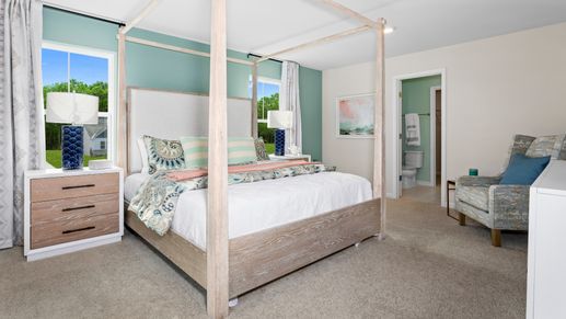 Carpeted owner's Suite with 2 large windows in a DRB Homes Whitehall Model at the Village of College Park community.