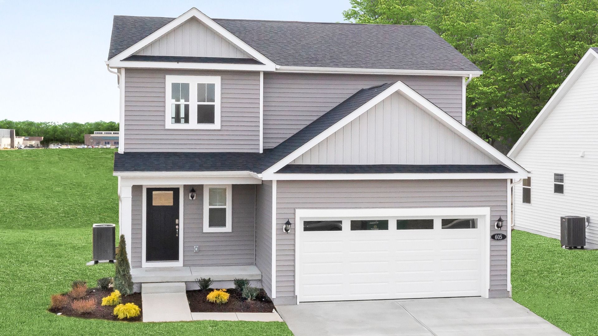 2 Story home with covered front entry of a DRB Homes Glenshaw plan at The Village of College Park.