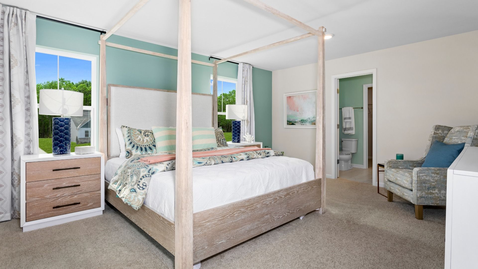 Carpeted owner's suite with 2 large windows in a DRB Homes Whitehall Model at the Village of College Park community.