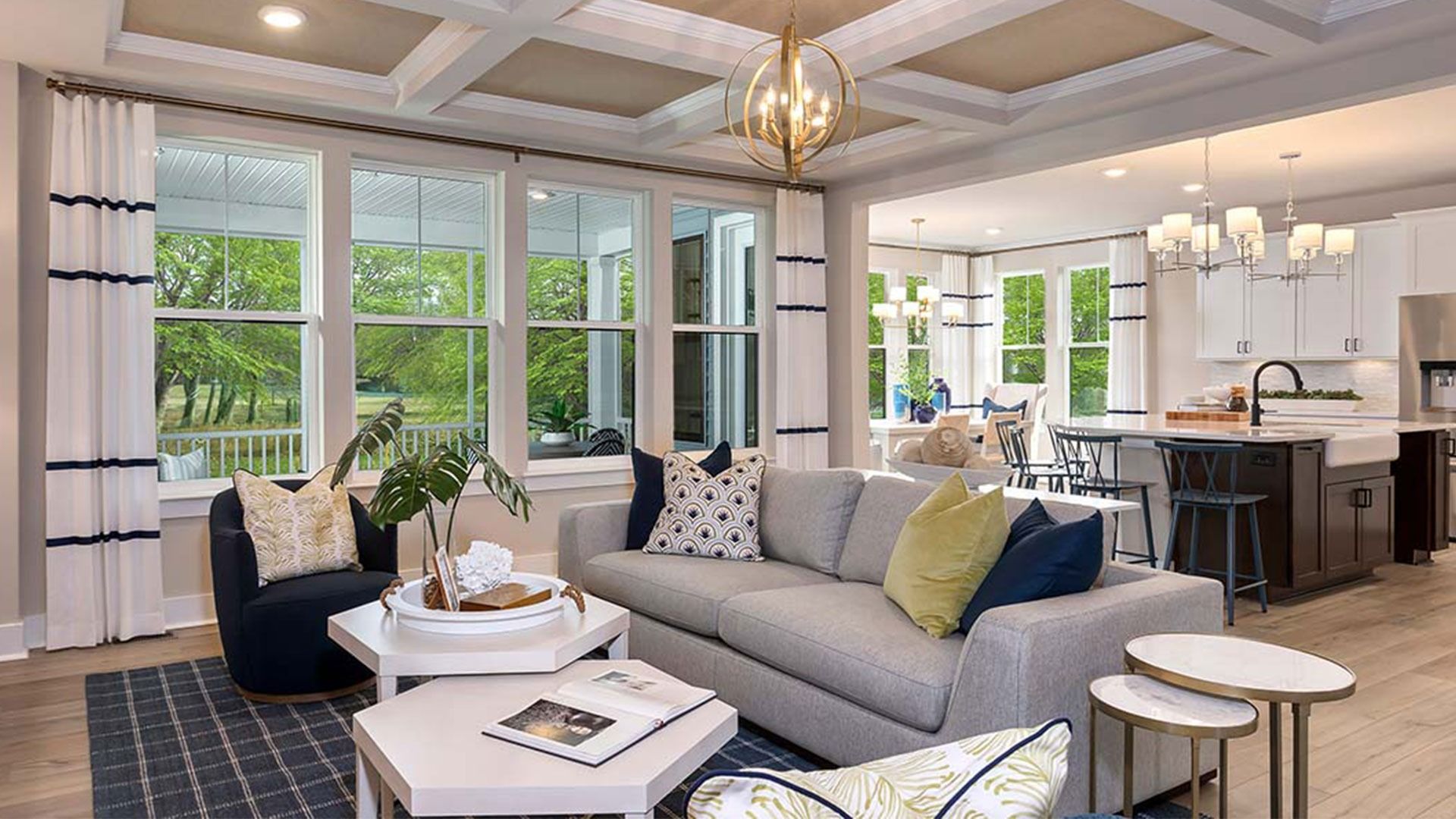 Beautiful open family room with quadruple window, coffered ceiling, recessed lights, light wood floors
