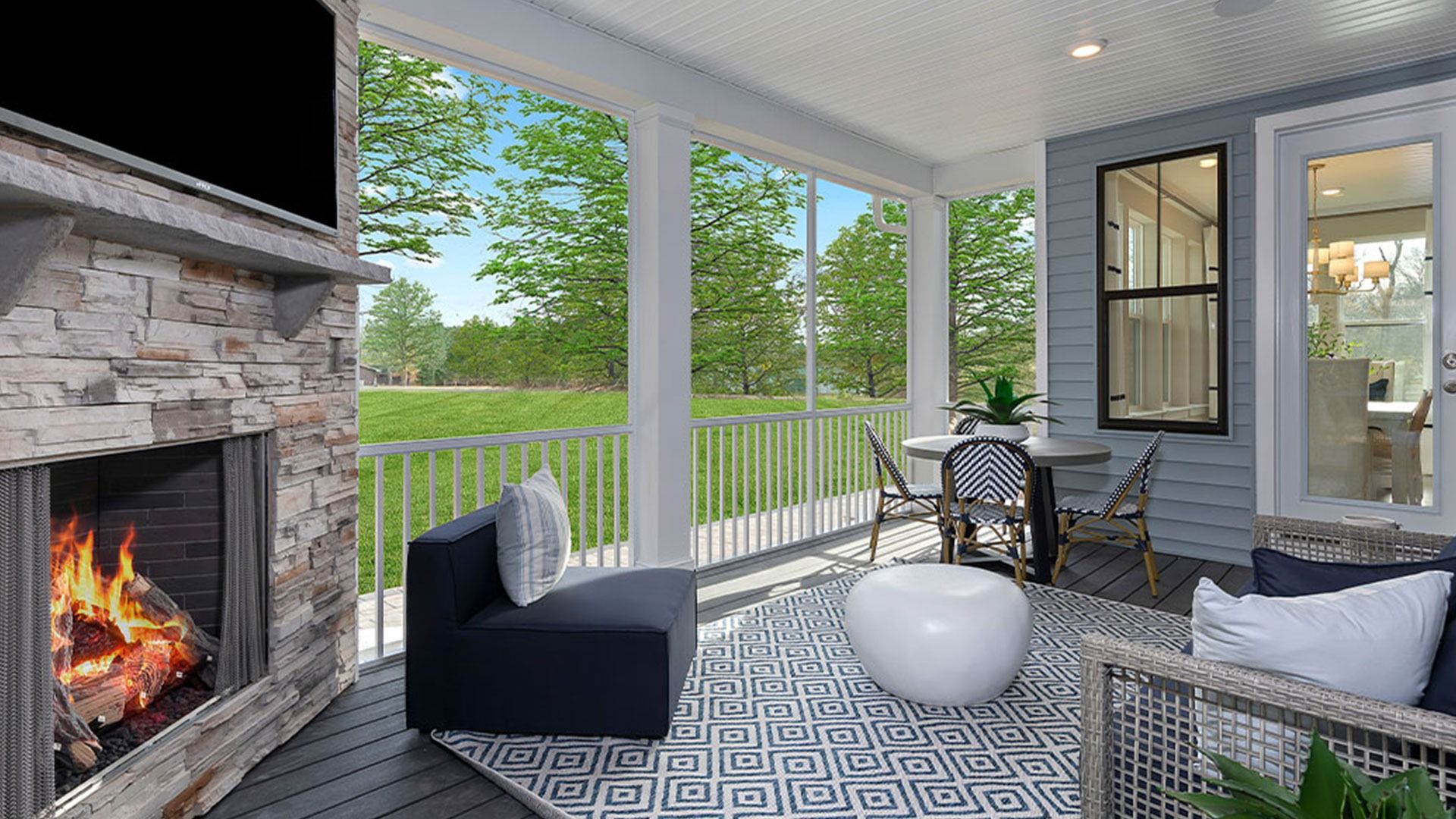 Spacious screened porch with gas fireplace and stacked stone surround and door access to the dining area