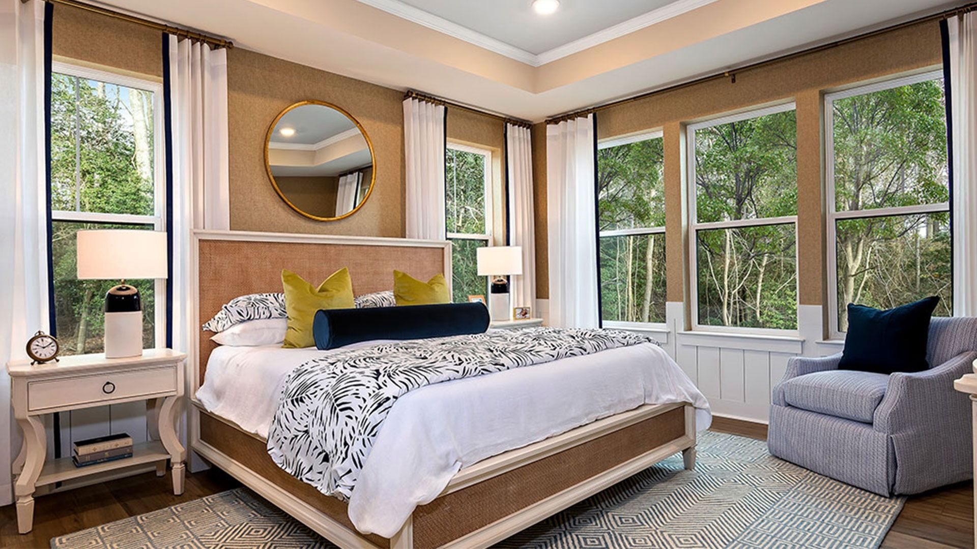Stunning owner's suite with 2 separate windows on 1 wall & triple window on adjacent wall, tray ceiling & recessed lighting.