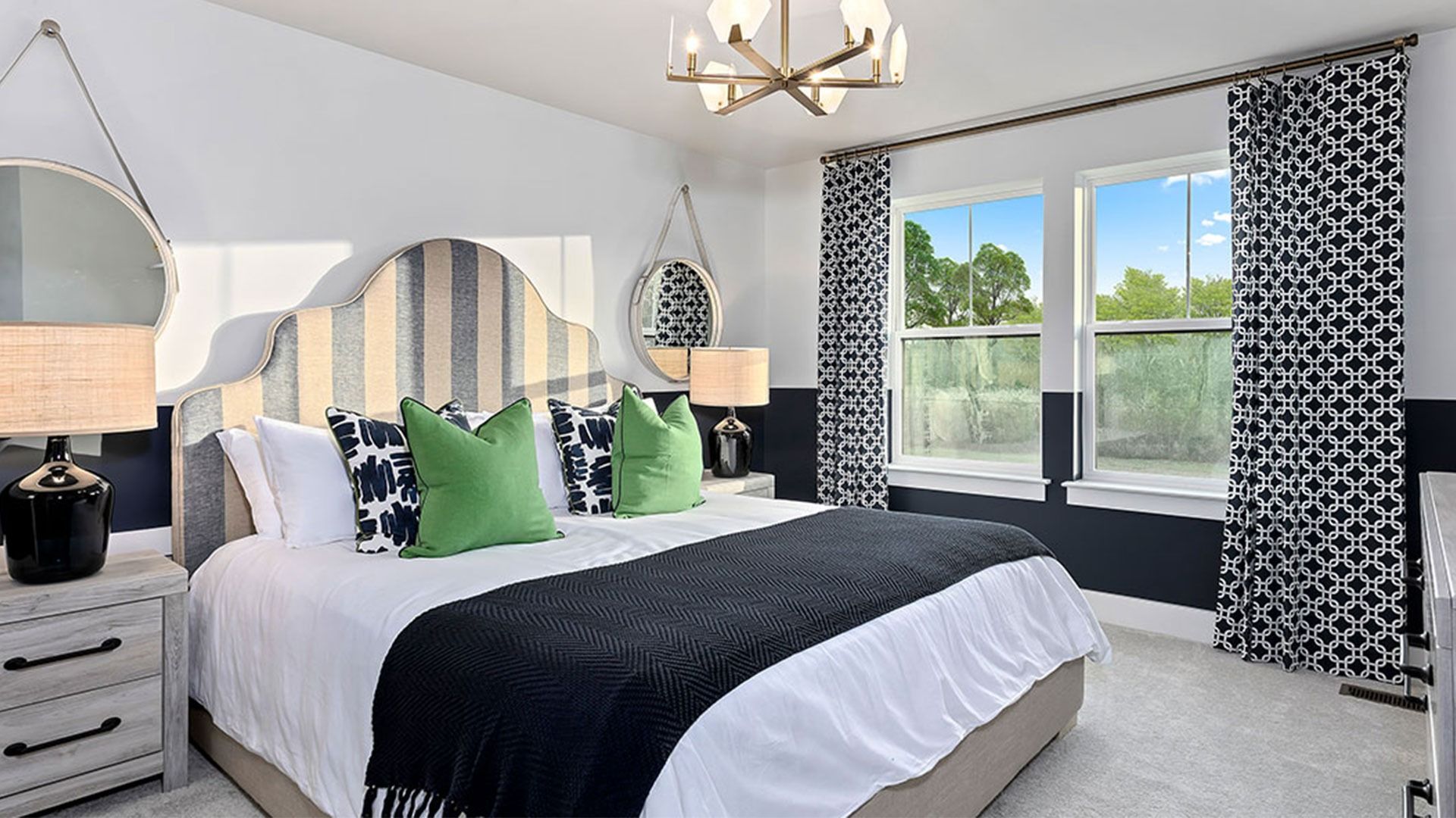 Secondary bedroom with wall to wall carpet and 2 large windows on one wall.