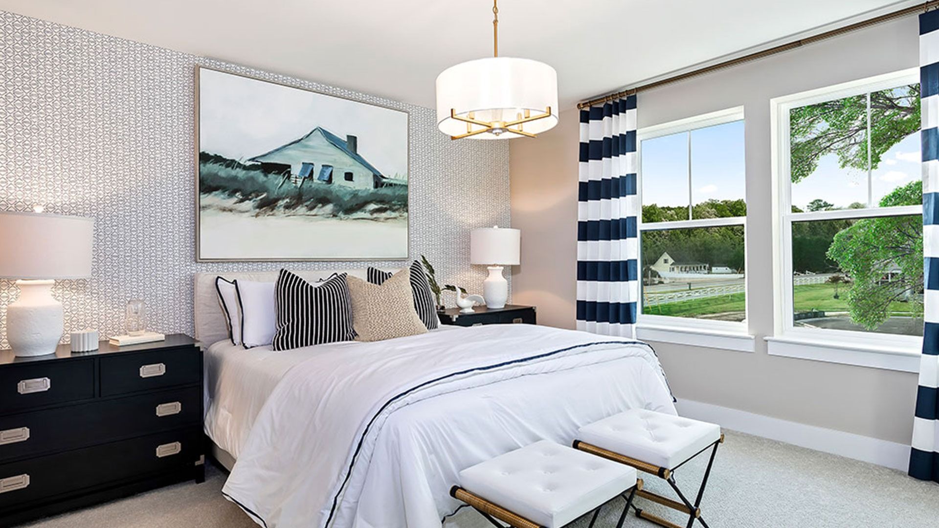 Secondary bedroom with light colored wall to wall carpet and 2 large windows on same wall.