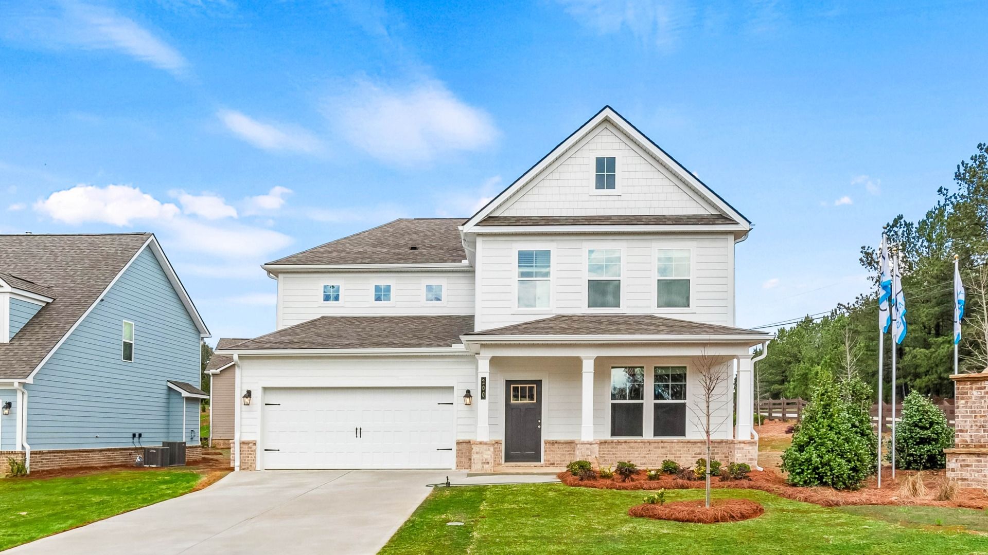 Modern exterior of Jordan model home with front entry two-car garage at Cooper Park in McDonough, GA.