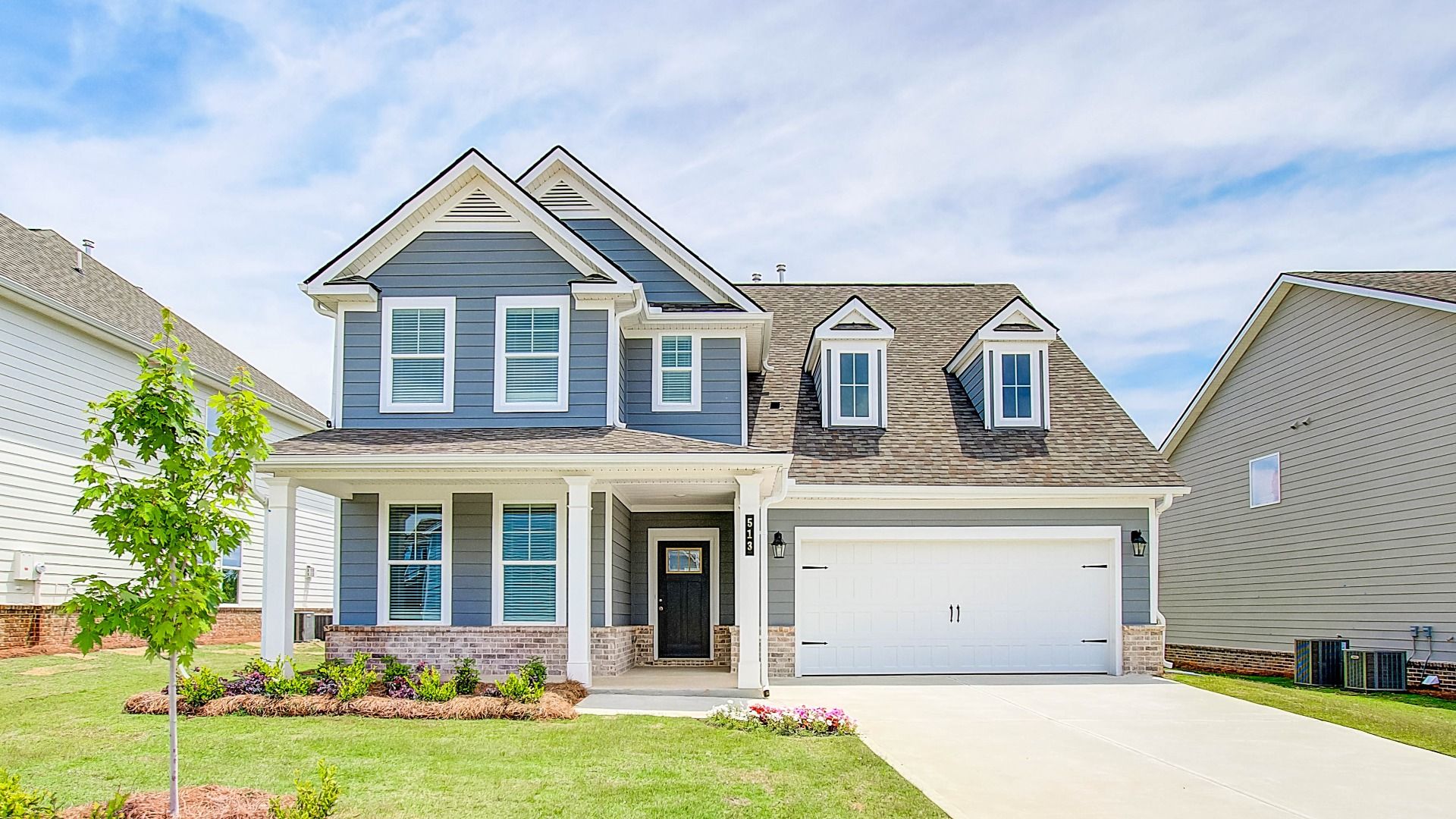 Jordan model two-story home with front-entry garage and covered entry at Cooper Park in McDonough, GA.