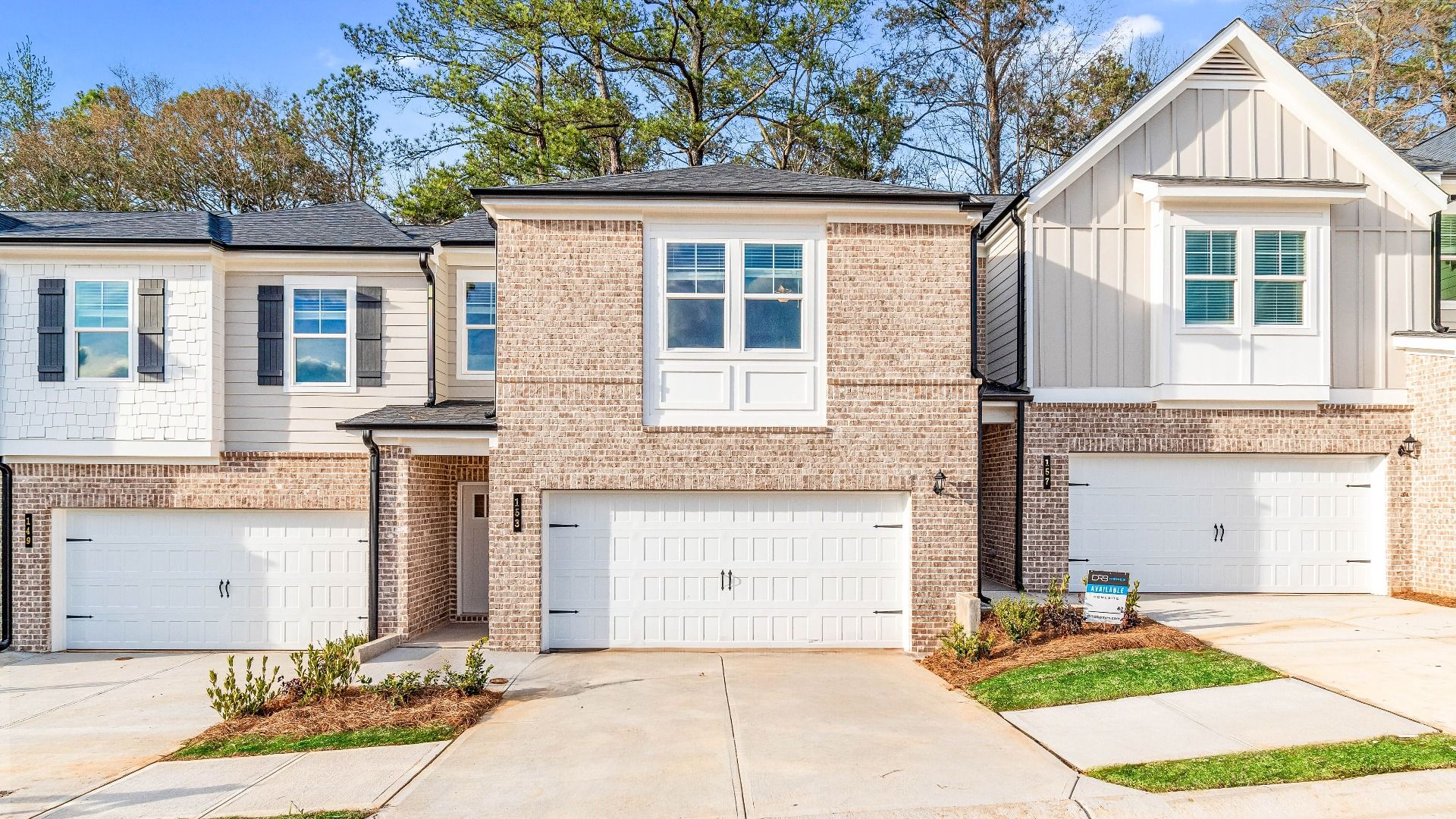 Austin two-story townhome featuring a primarily brick exterior with front entry garage and covered entry in Stockbridge, GA.