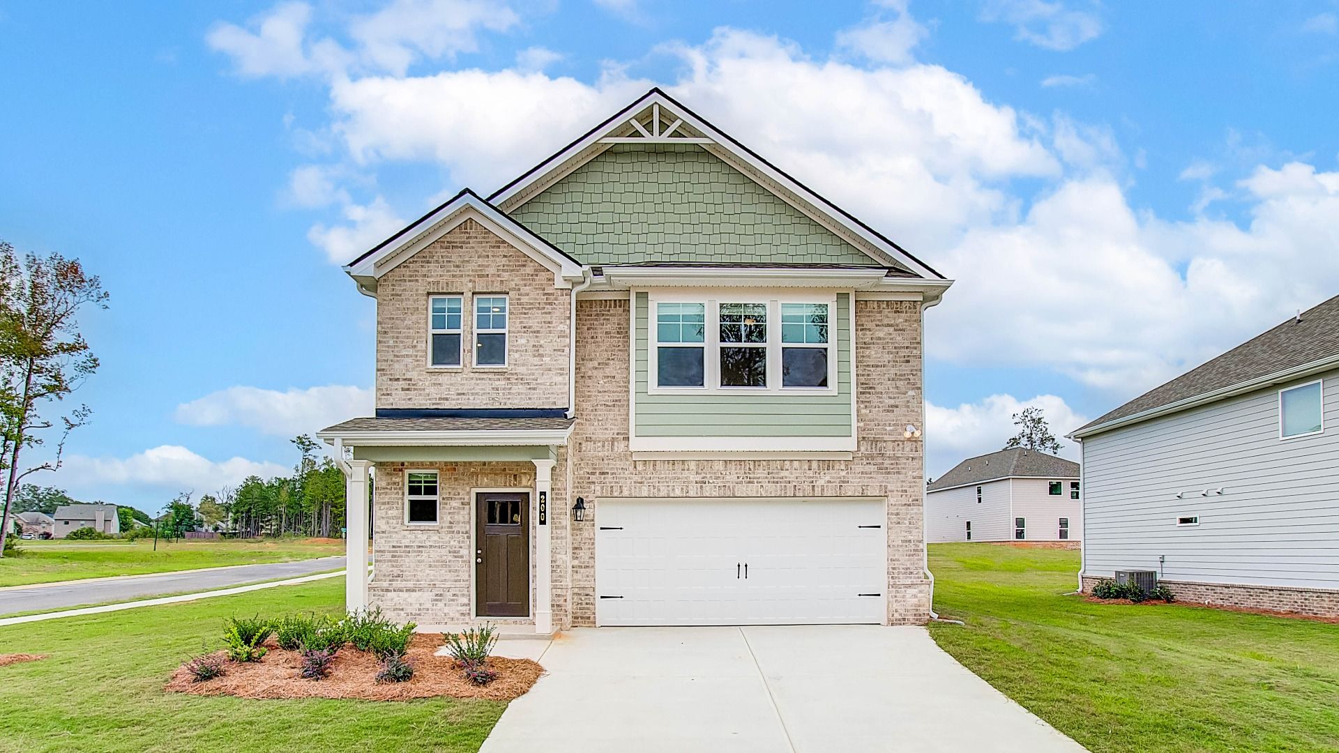 Zoey II new construction two-story single family home with front-entry garage at Westminster in Covington, GA.