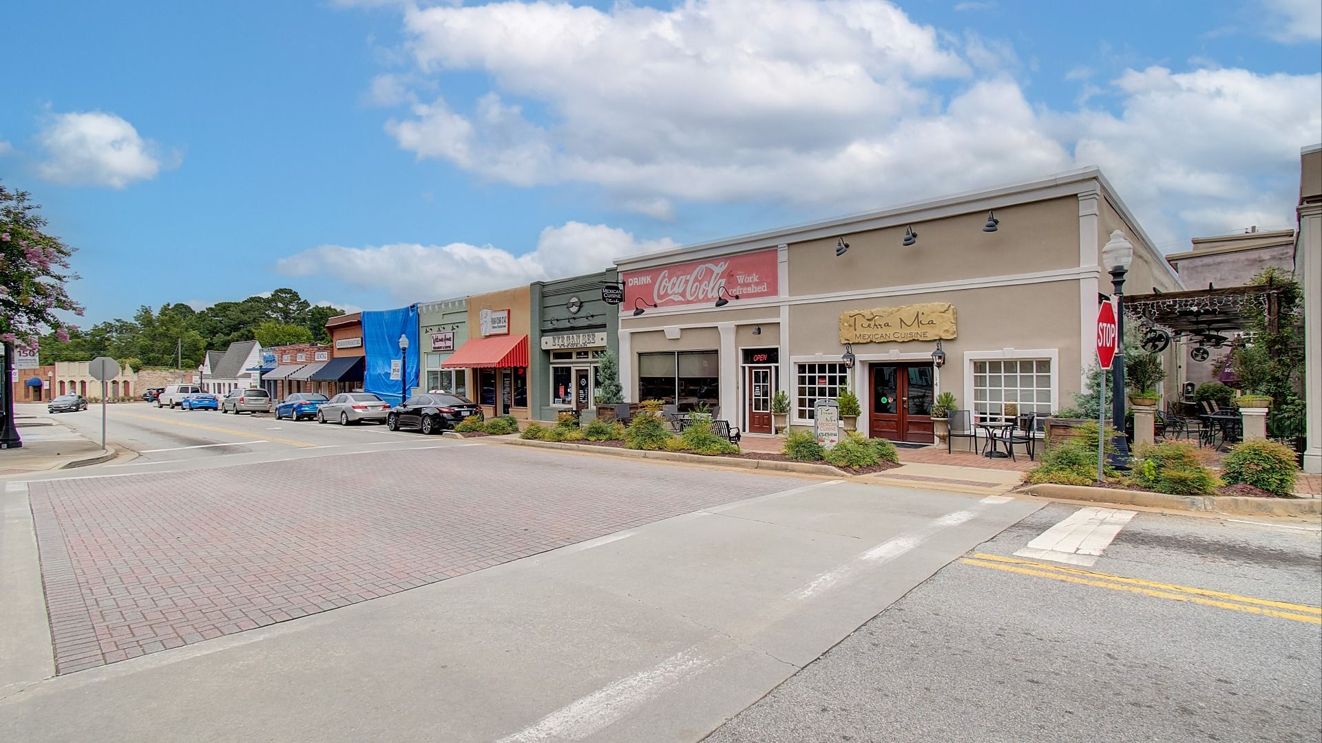 Downtown Hampton walkable strip featuring Tierra Mia Mexican Cuisine and Coca-Cola shop near Westwind Estates in Hampton, GA.