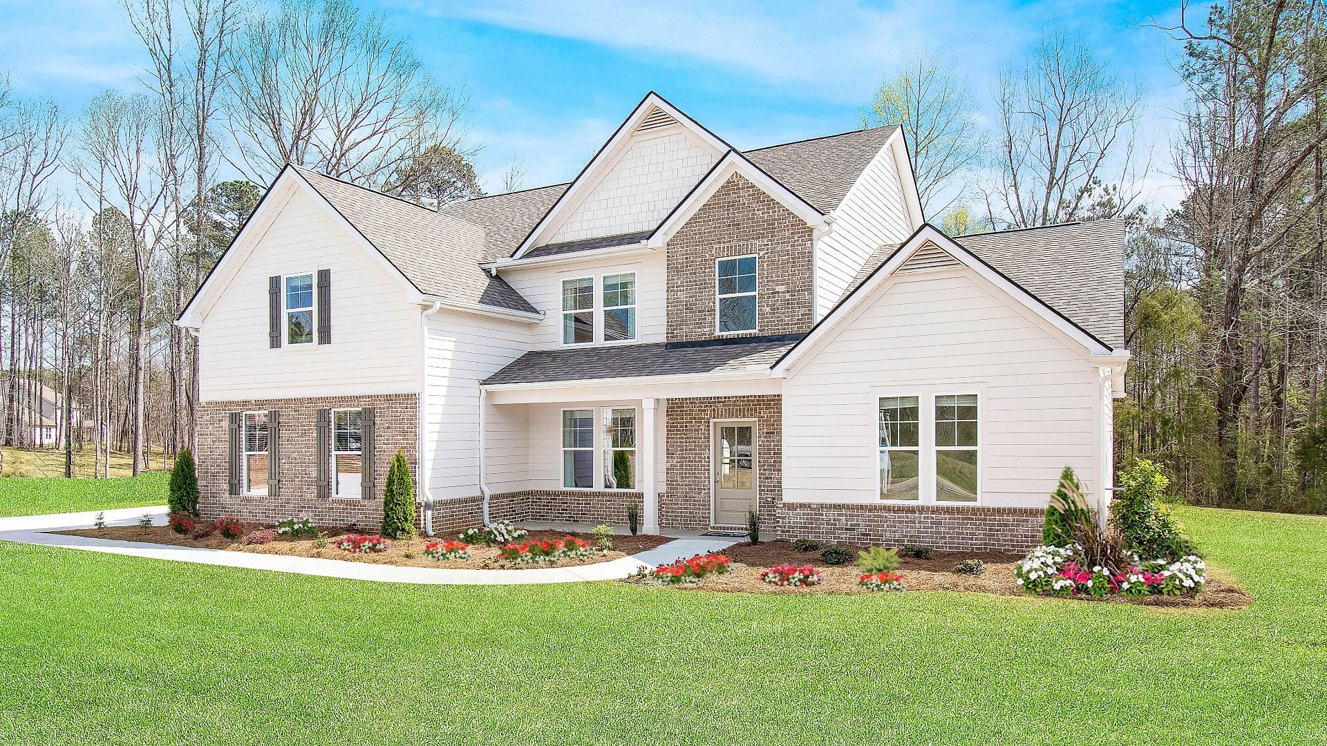 Two-story Henry II single-family home exterior with brick accents and covered entry at Saddleridge in Senoia, GA.