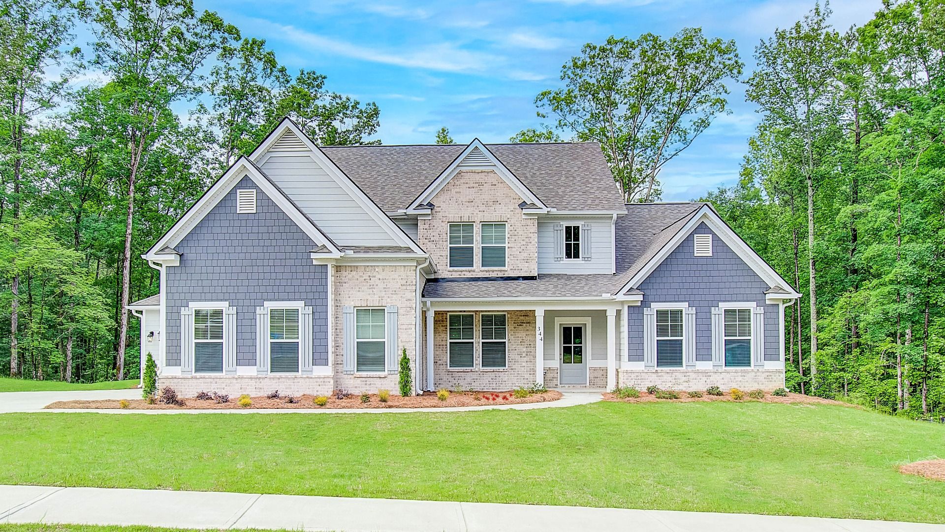Two-story Emerson II single-family home exterior with modern aesthetic and side-entry garage at Saddleridge in Senoia, GA.