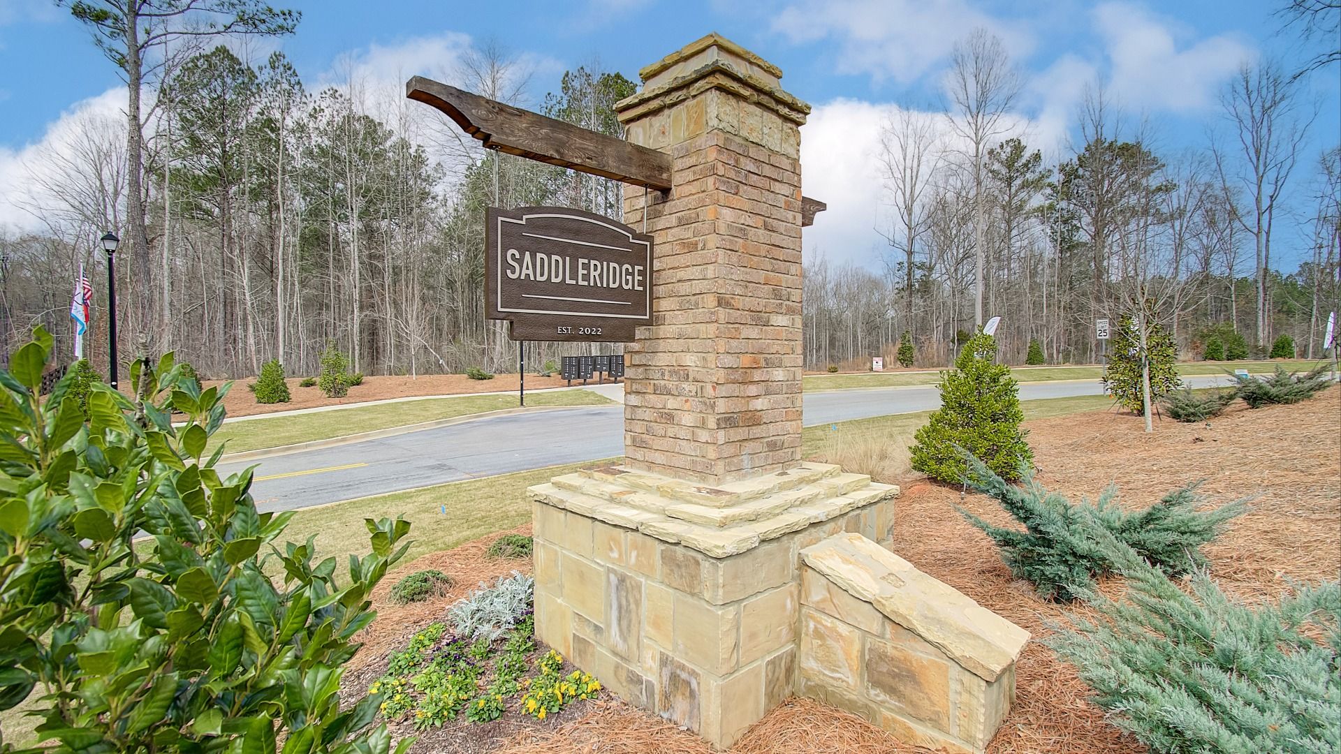Welcoming entry monument with brick and stone construction at Saddleridge in Senoia, GA.