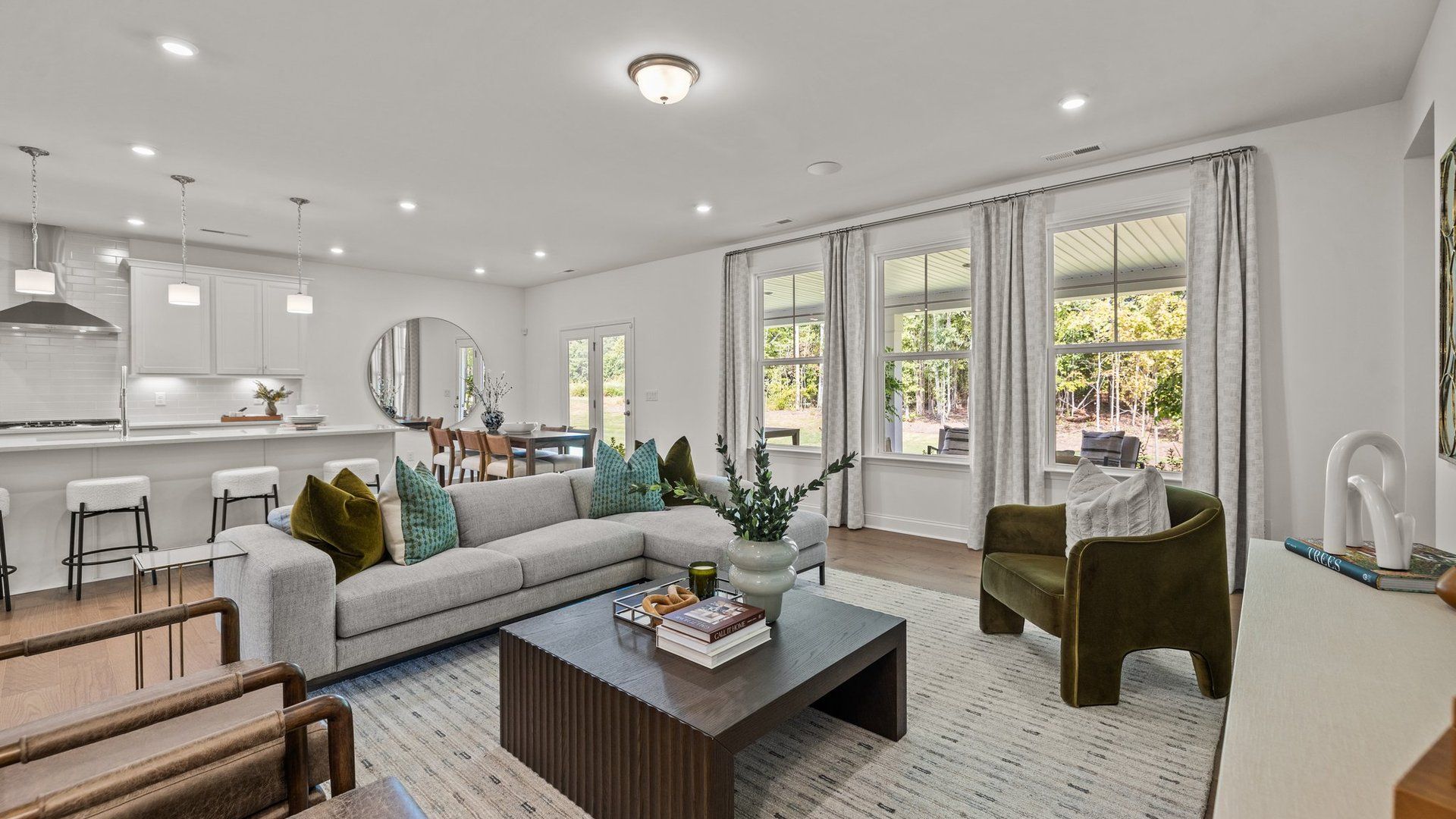 Family room with large windows and eat-in kitchen area in the Townsend plan by DRB Homes at Lakeside Glen in York, SC
