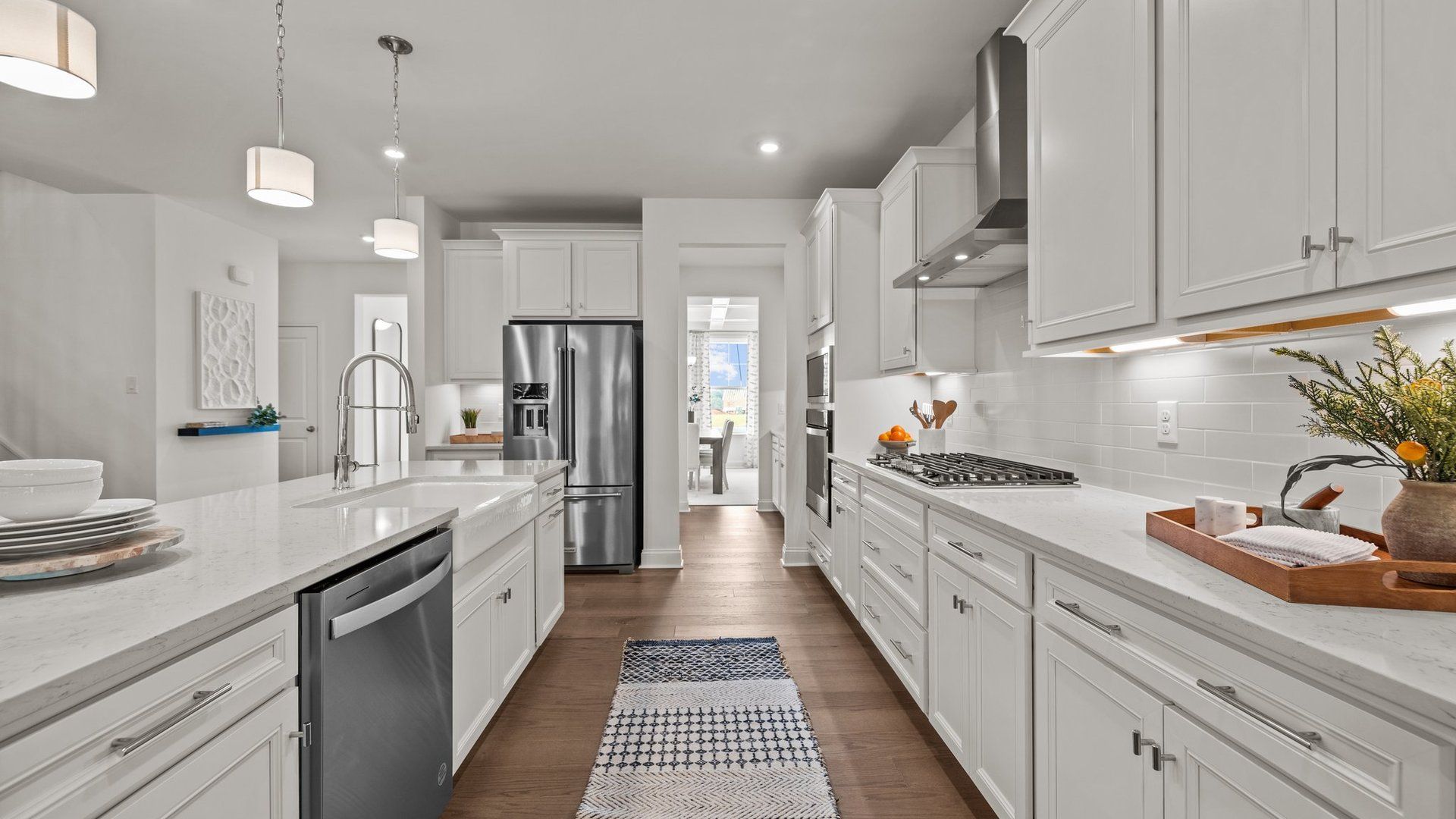 Gourmet kitchen with 36" gas cooktop, vented hood, 42" cabinets, and butler's pantry entrance at Lakeside Glen in York, SC