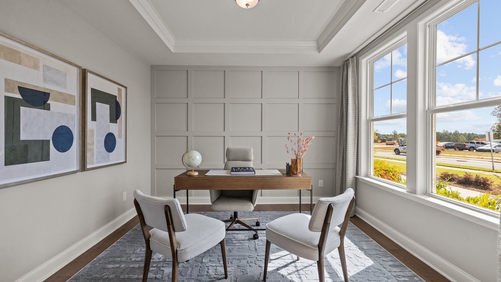 Study with tray ceiling and large windows adding natural light in the Townsend plan by DRB Homes in York, SC