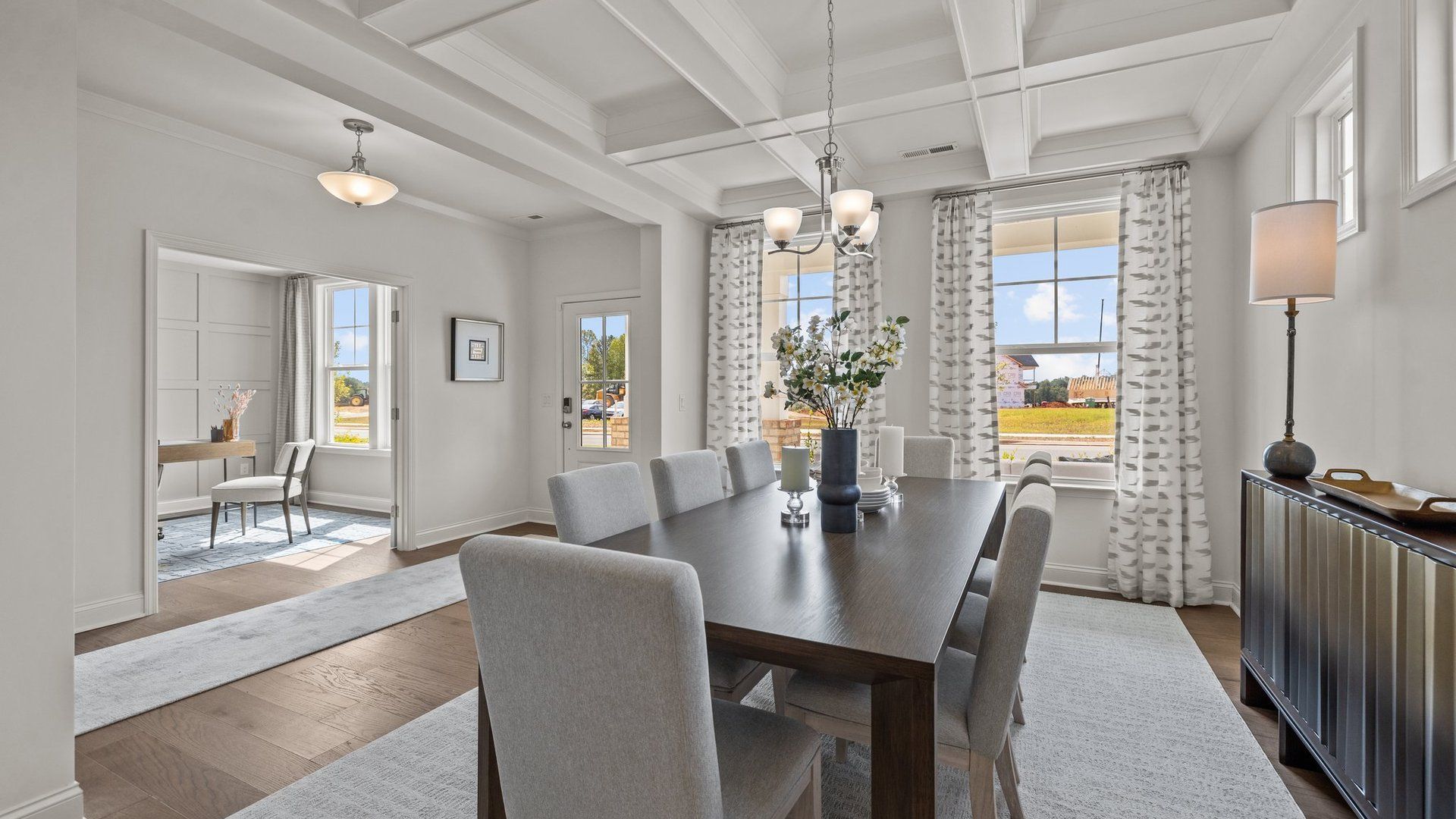 Elegant dining room with coffered ceiling and ample entrance to the study in the Townsend plan at Lakeside Glen in York, SC