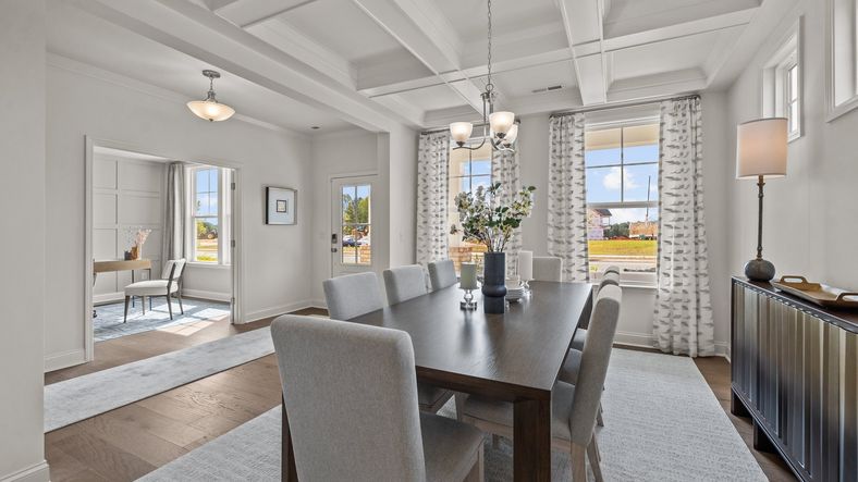 Elegant dining room with coffered ceiling and ample entrance to the study in the Townsend plan at Lakeside Glen in York, SC