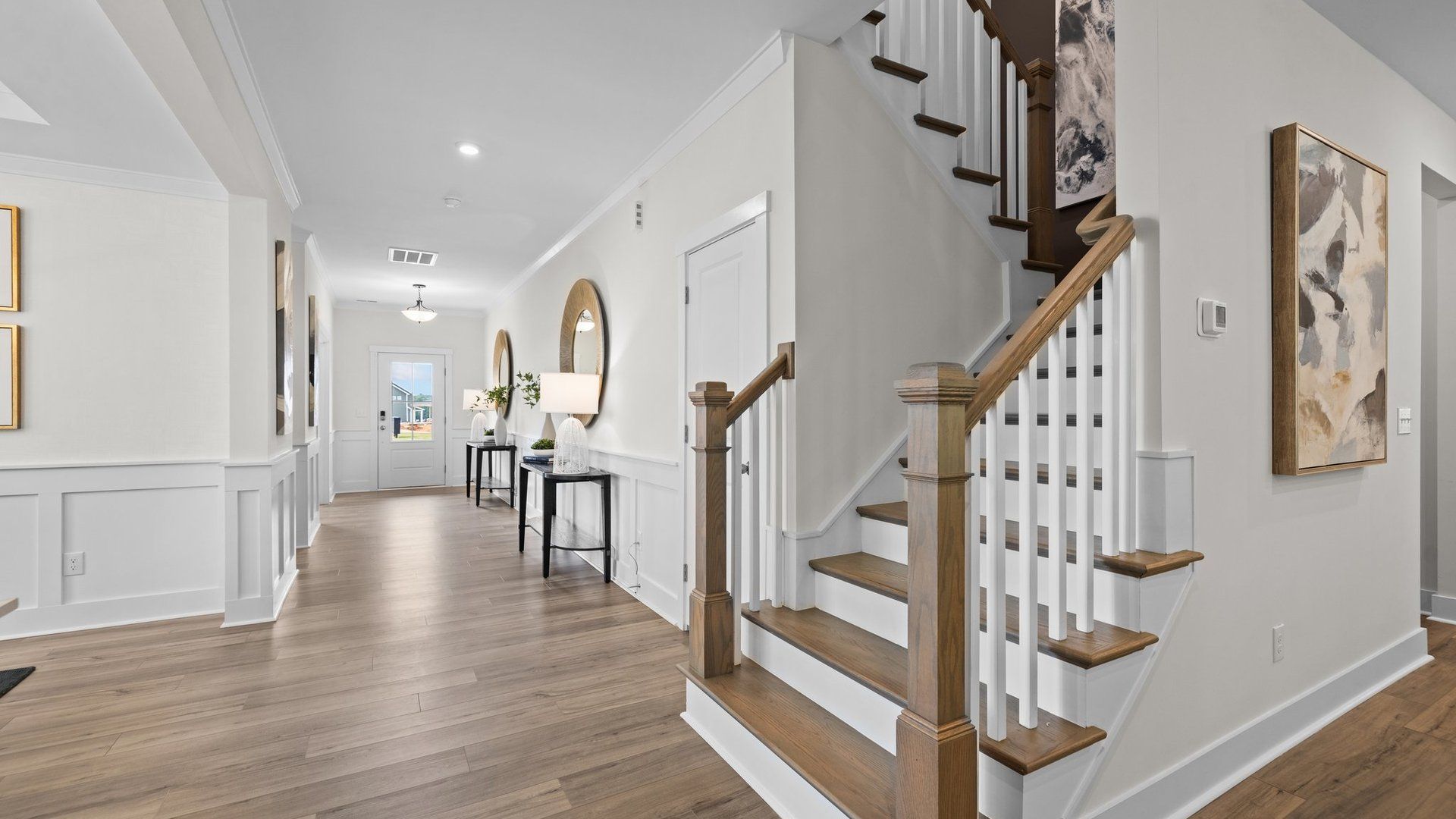 Ample and inviting front entrance with access to the study, dining, family room, and kitchen. Oak tread stairs with open rail