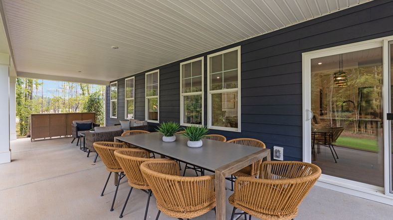 The Jordan rear covered porch with comfortable seating for outdoor eating or relaxing. Lakeside Glen. DRB Homes. York, SC.
