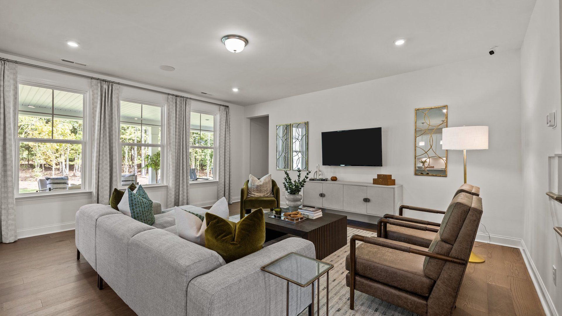 Spacious and bright family room with elevated ceiling and large windows, in the Townsend Design by DRB Homes in York, SC