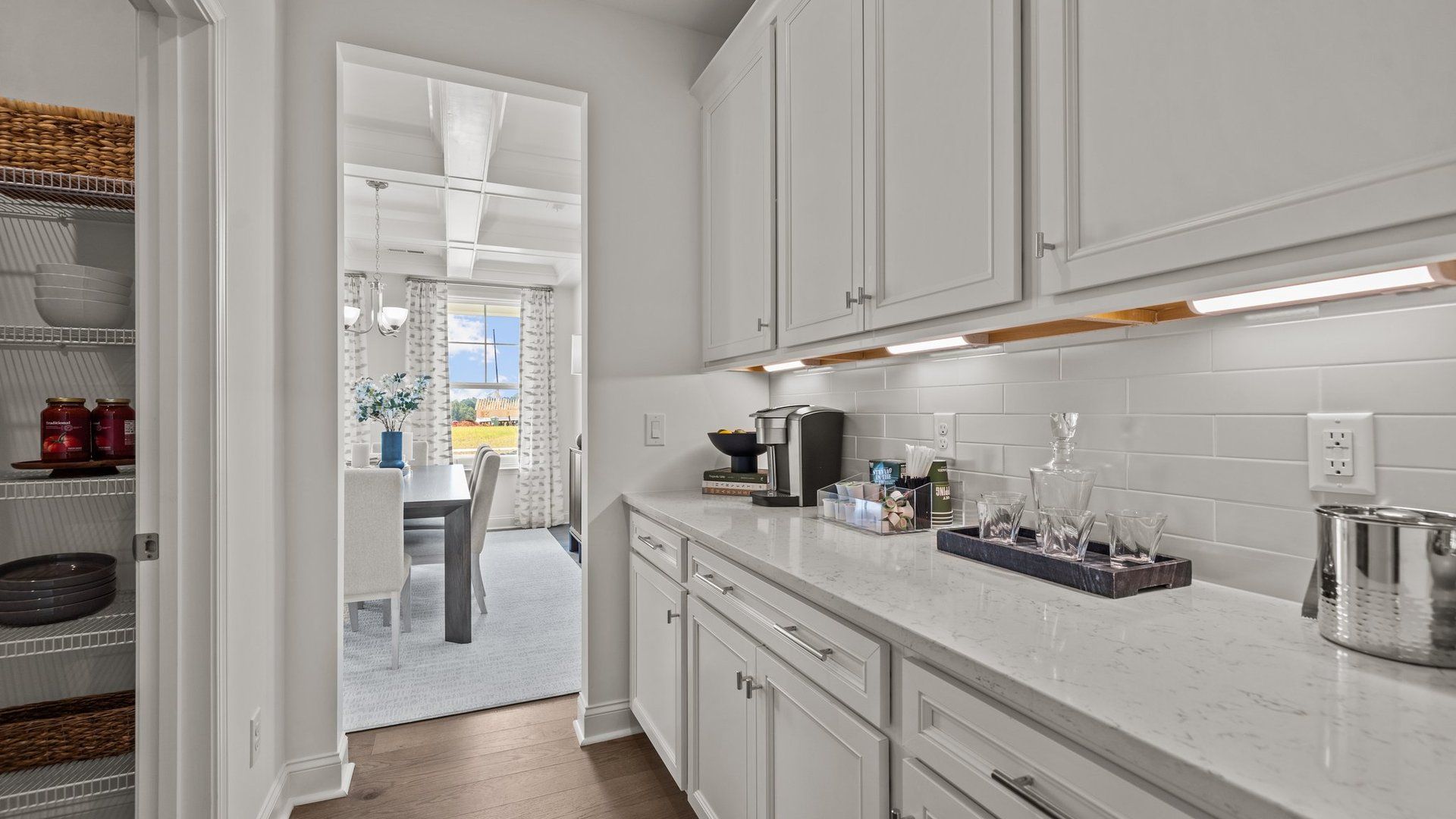 Exclusive butler's pantry with under-cabinet lighting and quartz counter tops in the Townsend Design by DRB Homes in York, SC