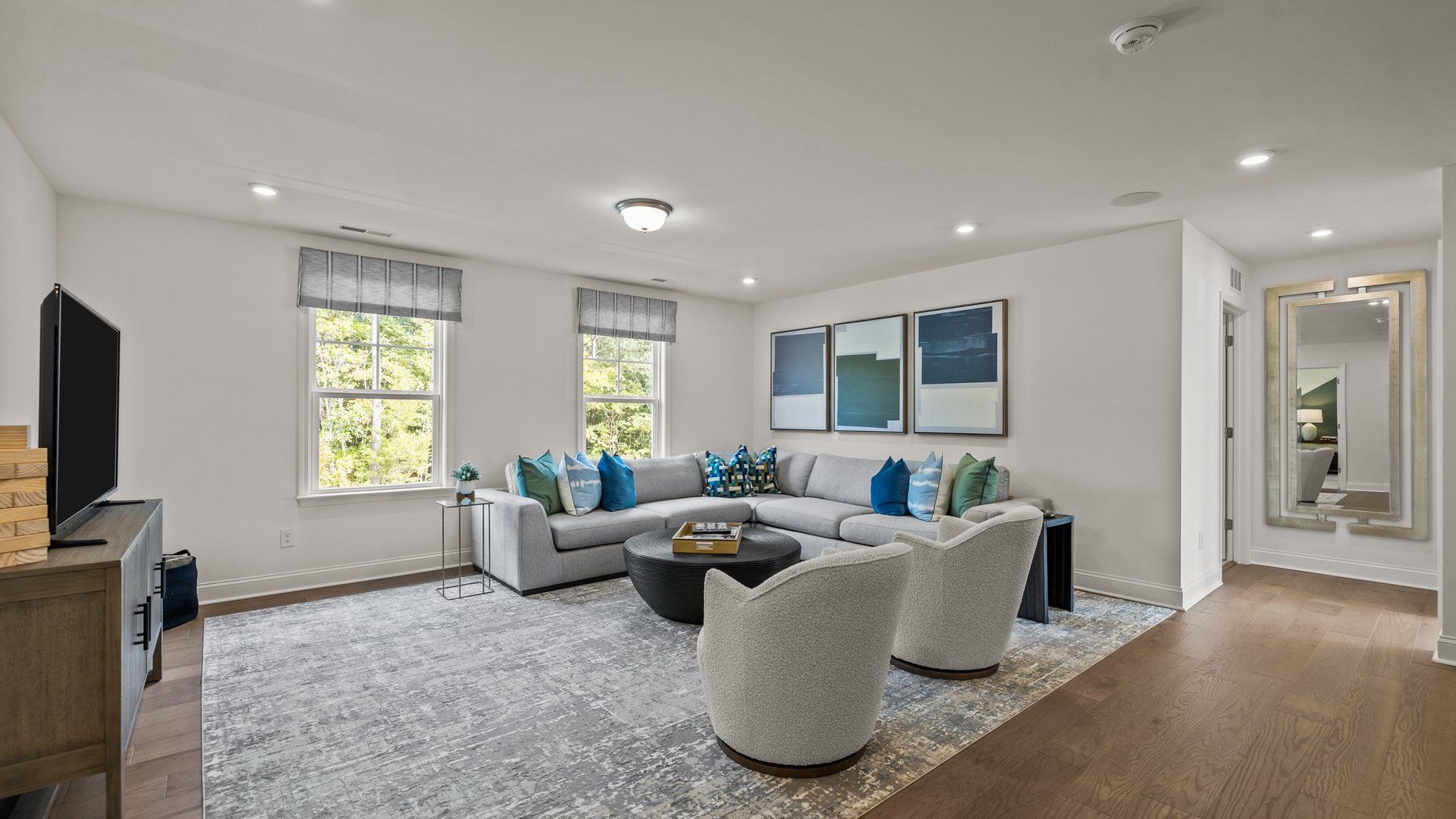 Flexible multi-use loft with elevated ceiling and large windows in the Townsend Design by DRB Homes in York, SC