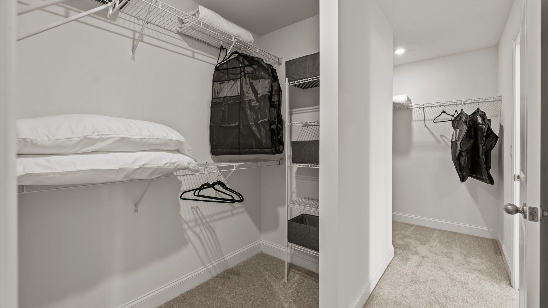 Large dual walk-in closets with elevated ceiling and plush carpeting in the Townsend Design by DRB Homes in York, SC