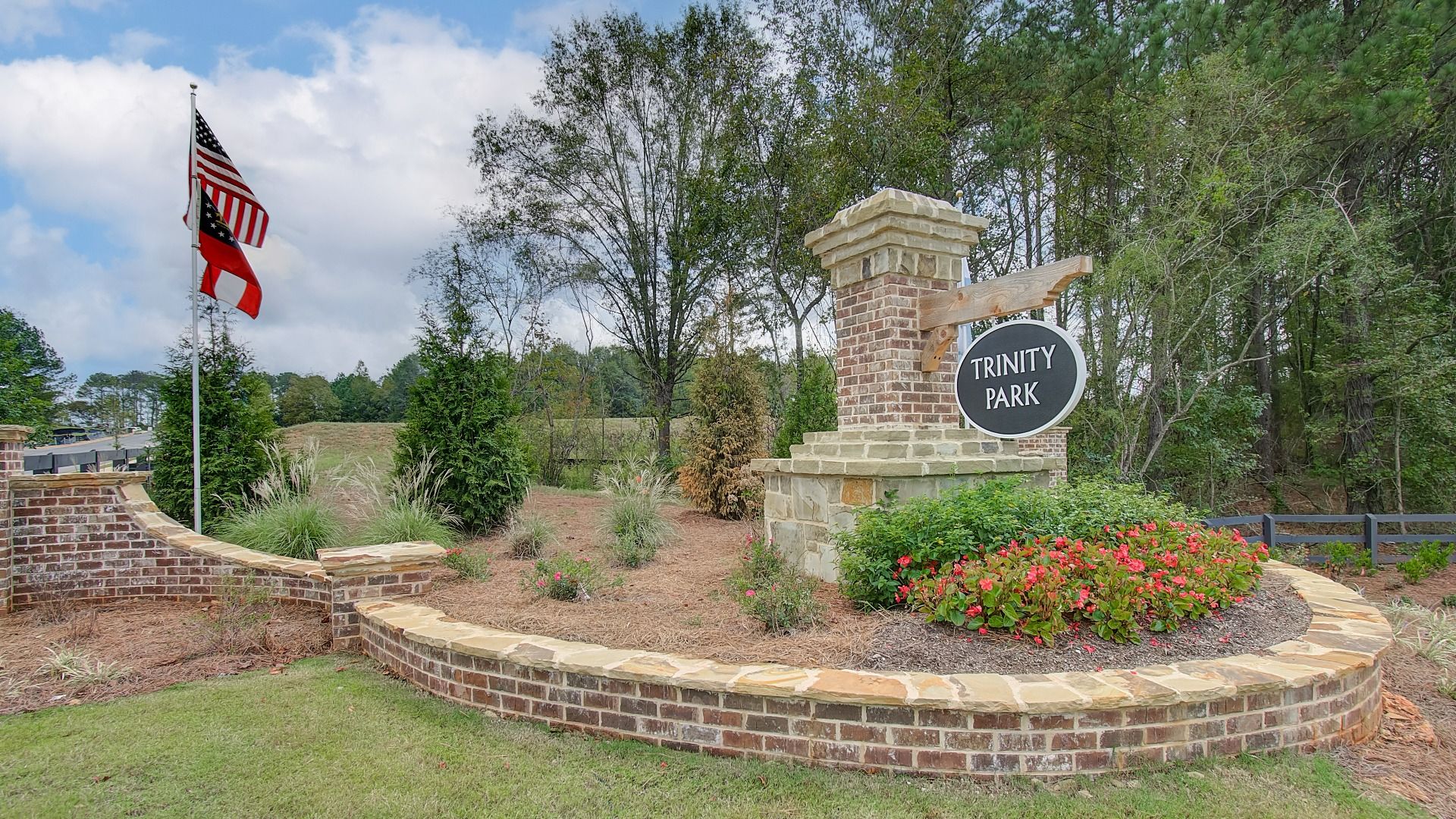Welcoming entry monument with brick and stone construction at Trinity Park in McDonough, GA.