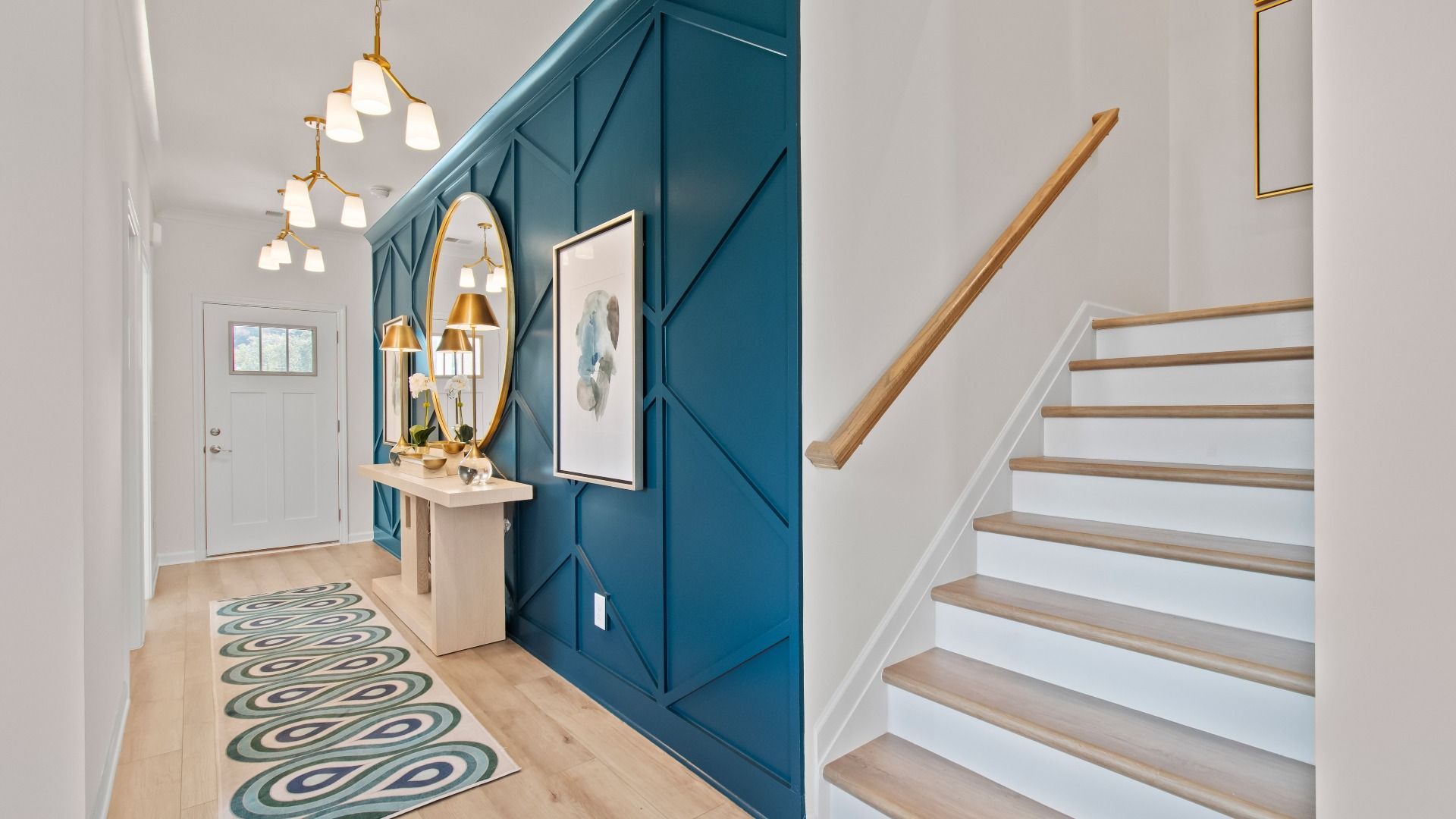 Wagener open foyer and staircase with LVP flooring and modern finishes at Burchwood in Stockbridge, GA.