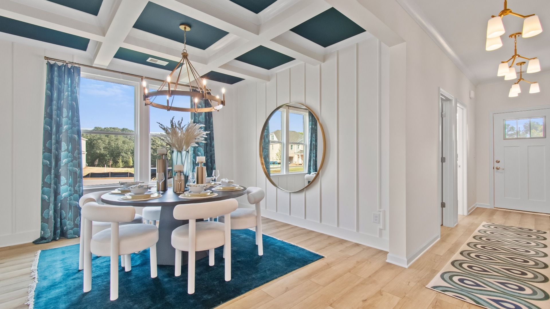 Wagener bright open dining room with coffered ceiling, LVP flooring and modern finishes at Burchwood in Stockbridge, GA.