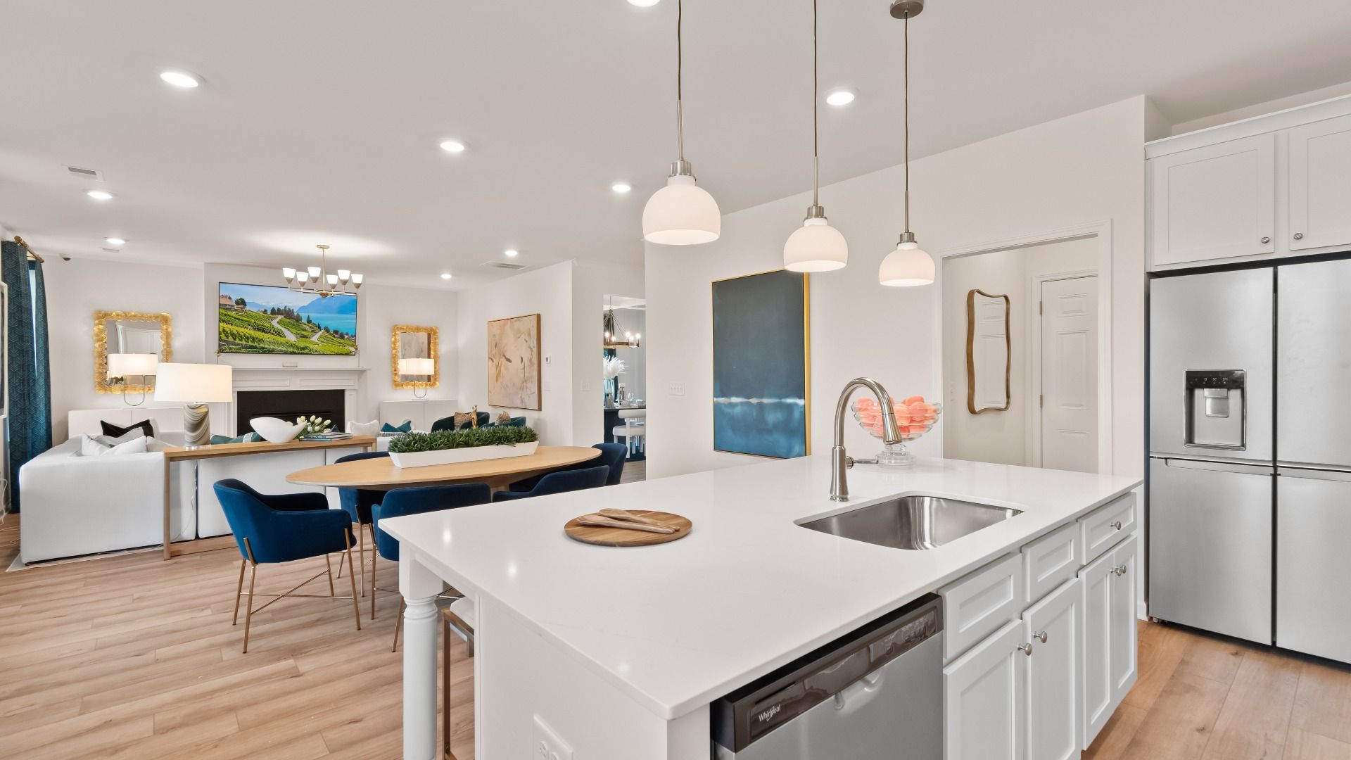 Wagener open-concept kitchen with white cabinetry, pendant lighting, and island overlooking breakfast area at Burchwood.