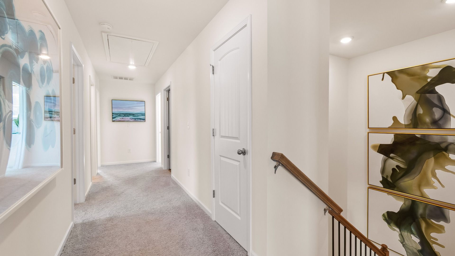 Wagener upstairs landing with open hallway and carpet flooring at Burchwood in Stockbridge, GA.