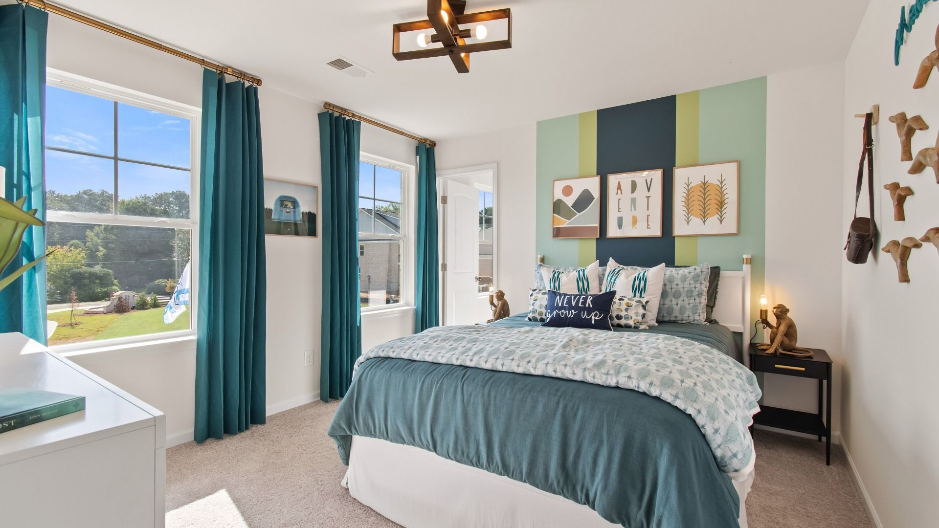 Secondary bedroom with carpet flooring, natural light, and neutral finishes in the Wagener at Burchwood in Stockbridge, GA.