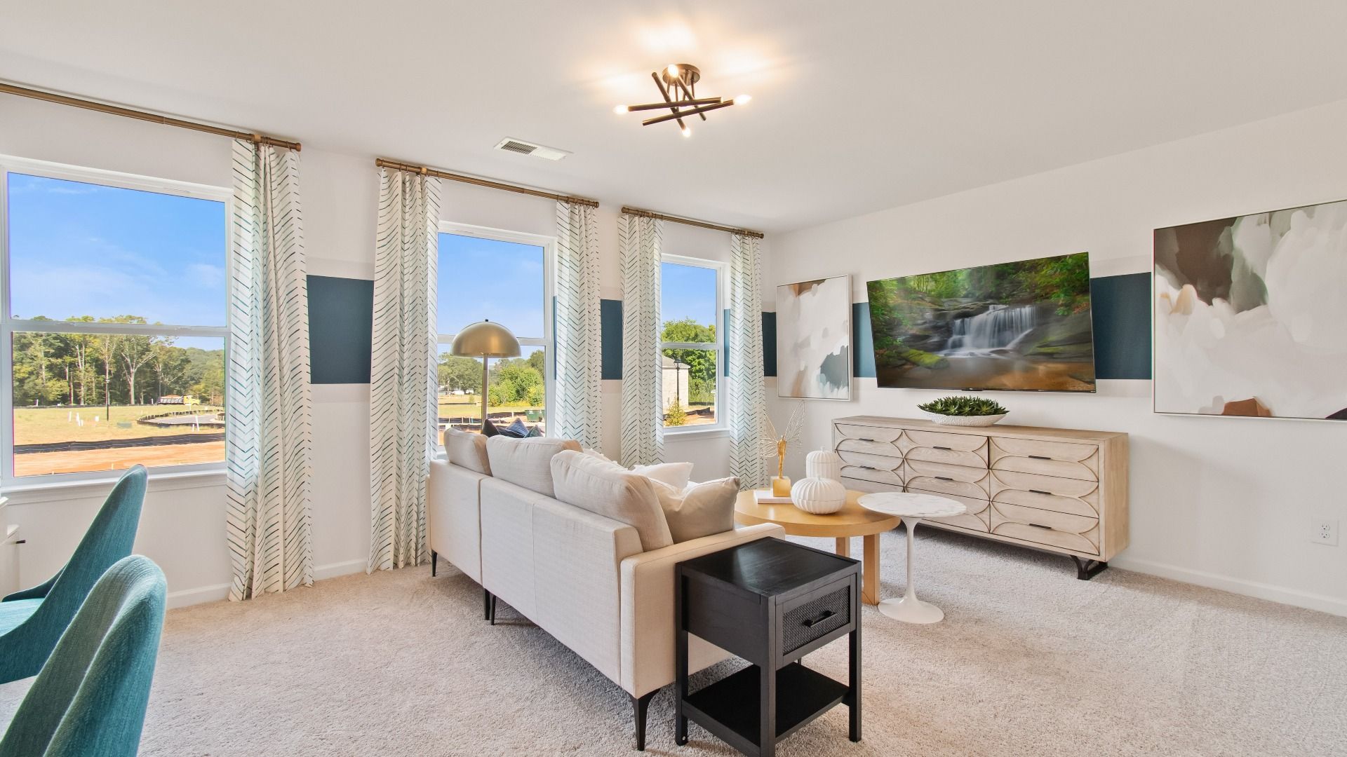 Wagener spacious open loft for flexible use with carpet flooring and natural light at Burchwood in Stockbridge, GA.