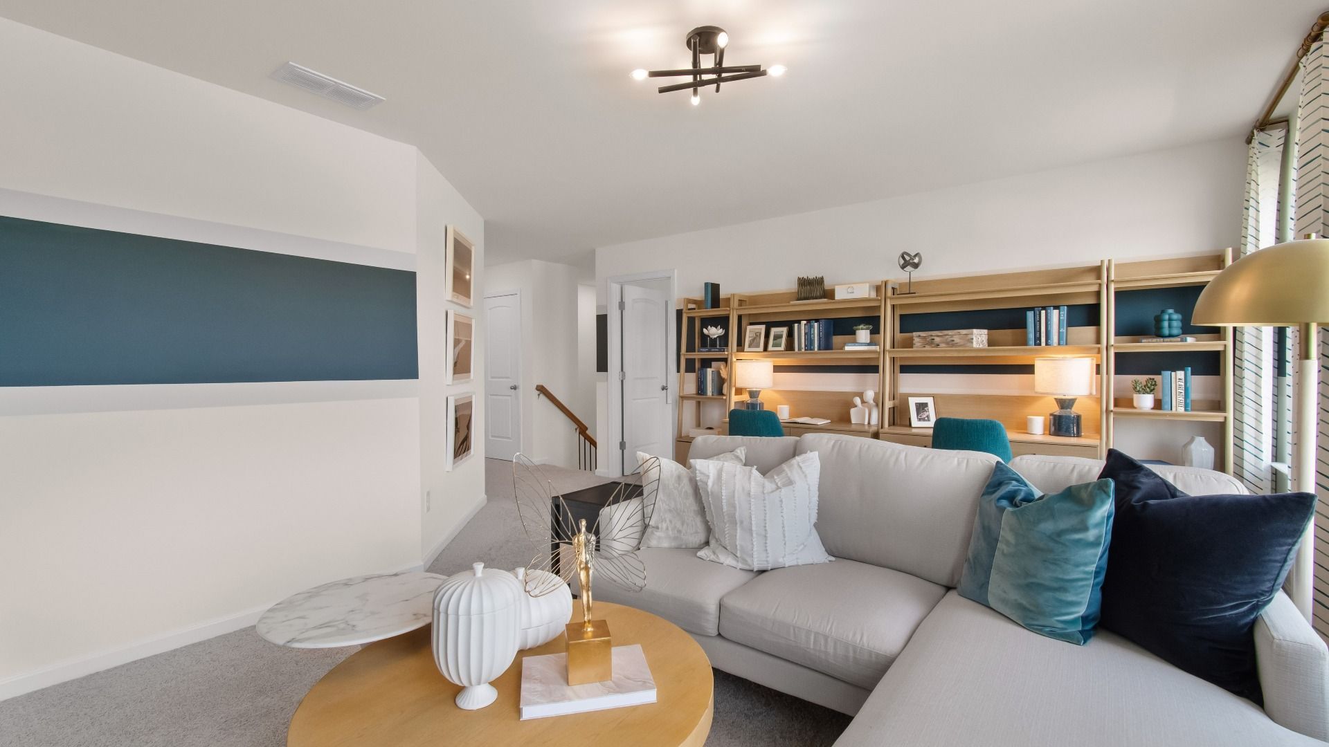 Bright loft lounge and work space with modern open layout and natural light at Burchwood in Stockbridge, GA.