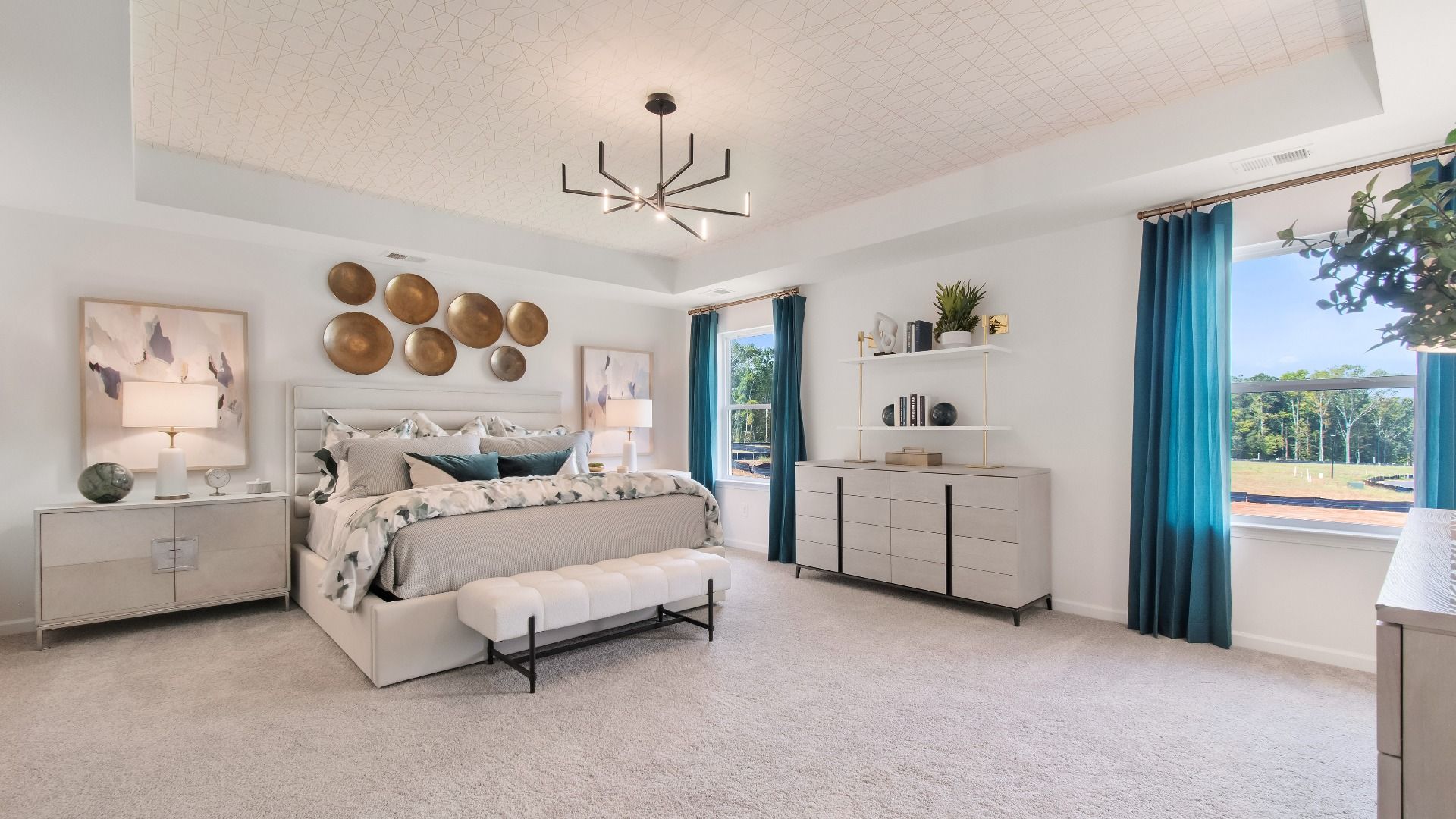 Elegant primary suite with tray ceiling, expansive windows, and carpeted floors in new construction homes in Stockbridge, GA.