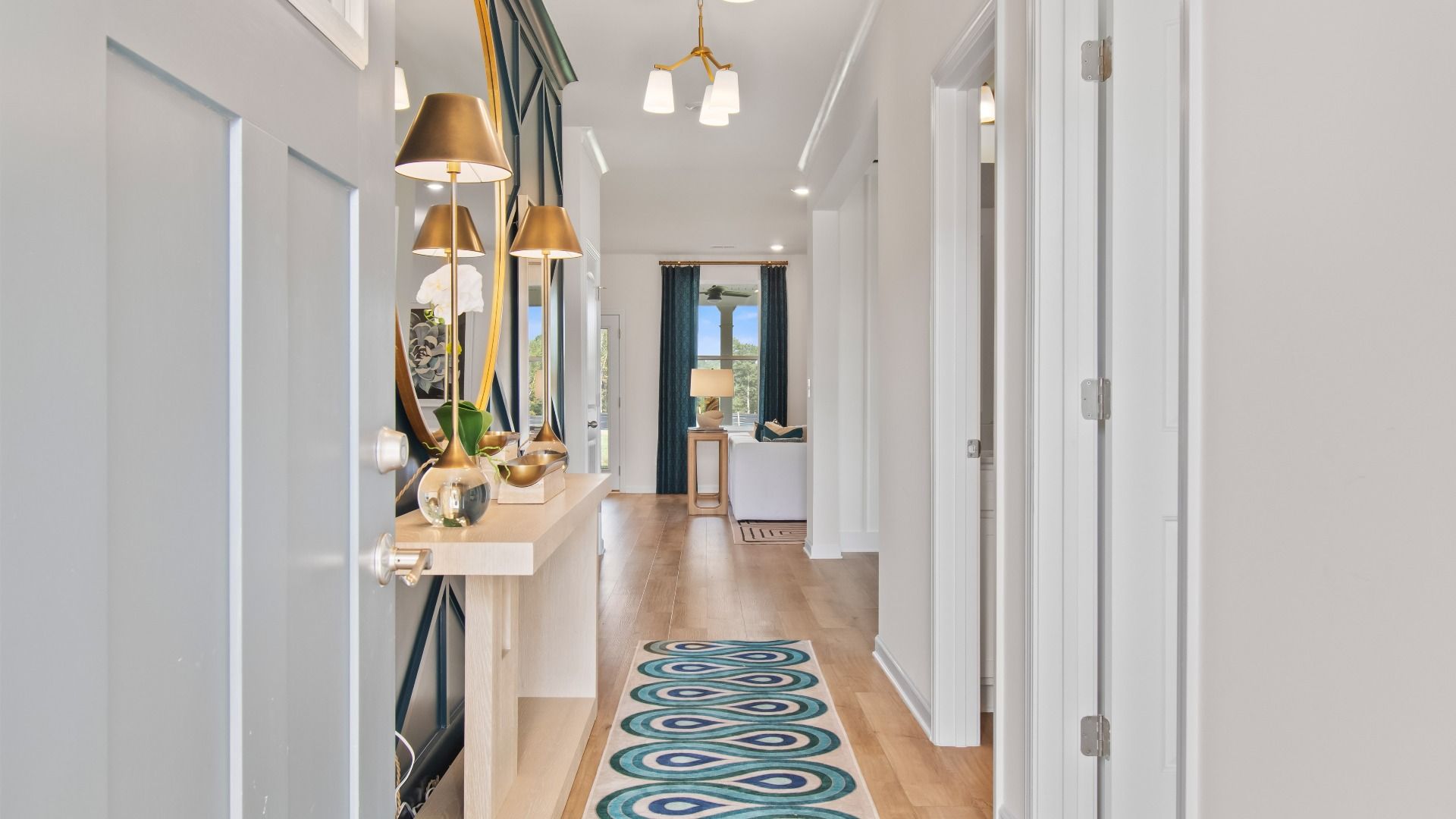 Bright Wagener entryway featuring open foyer with LVP flooring at Bowers Farm in McDonough, GA.