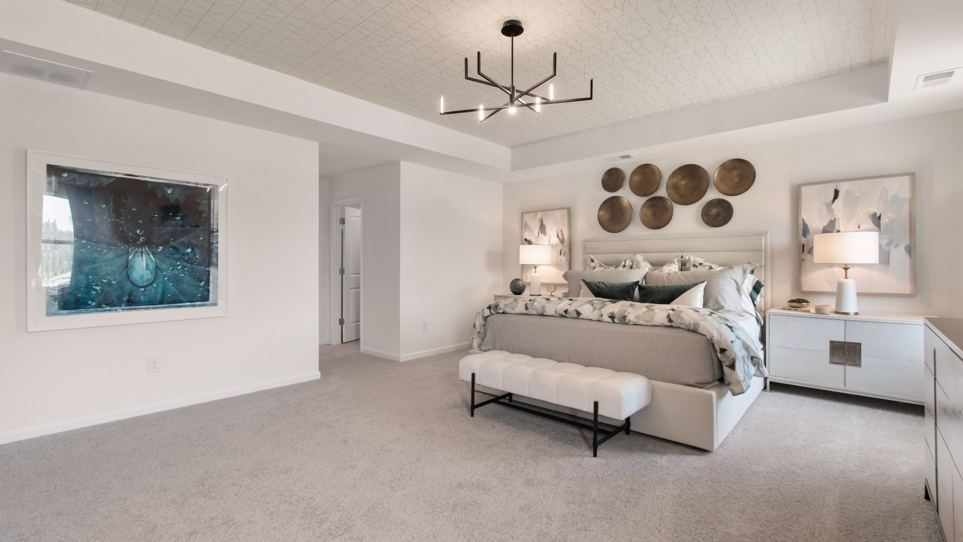 Luxurious Wagener primary suite with spacious room, tray ceiling, and neutral modern finishes at Bowers Farm.