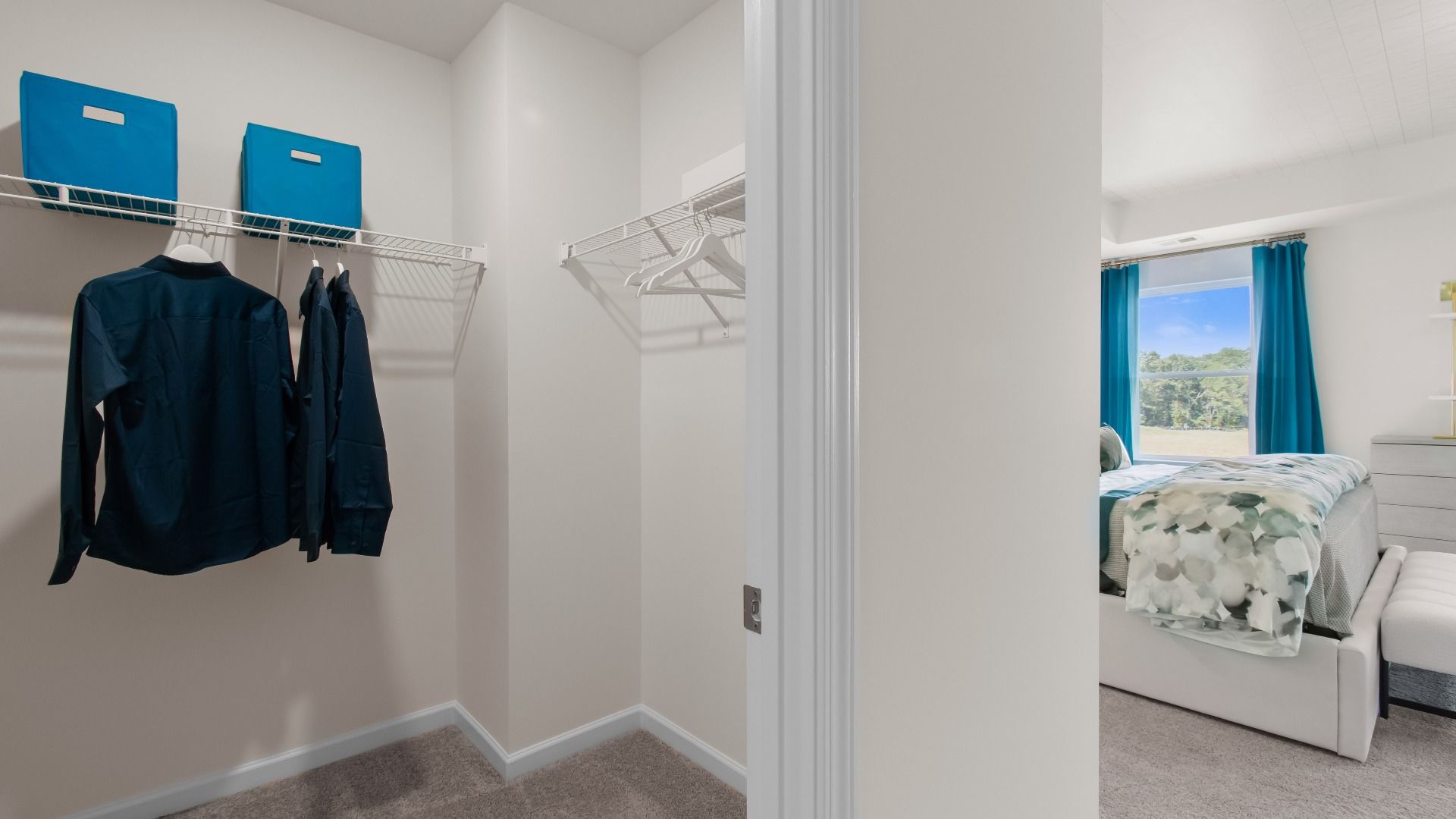 Wagener primary closet with built-in shelves for storage and carpet flooring at Bowers Farm in McDonough, GA.