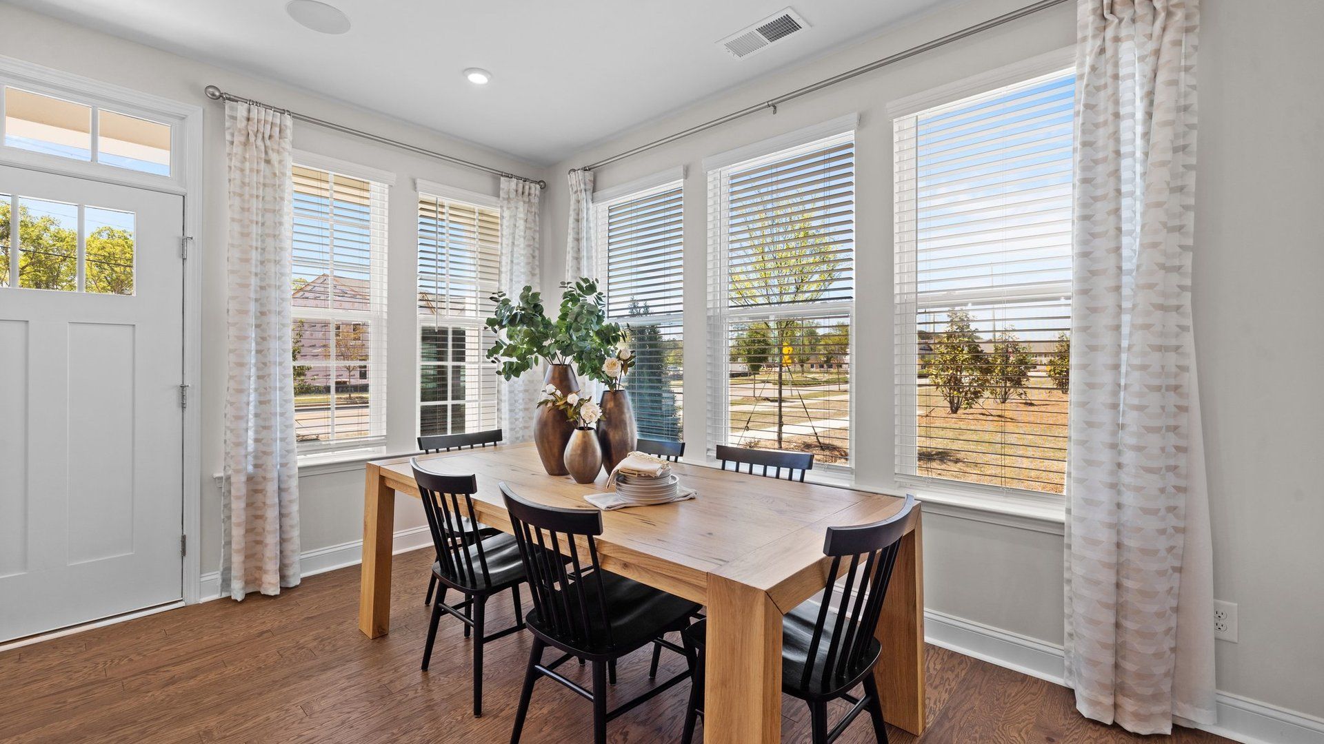 Bright dining area with large windows and elevated ceiling in the new Rochester Design by DRB Homes Charlotte, NC