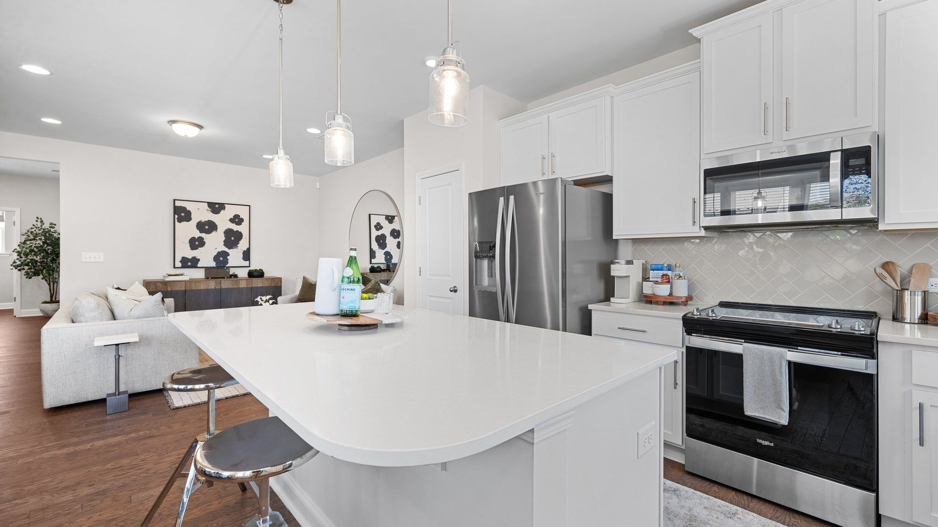 Kitchen with quartz countertops, cascading upper cabinets and premium lighting in the Rochester Design by DRB Homes Charlotte