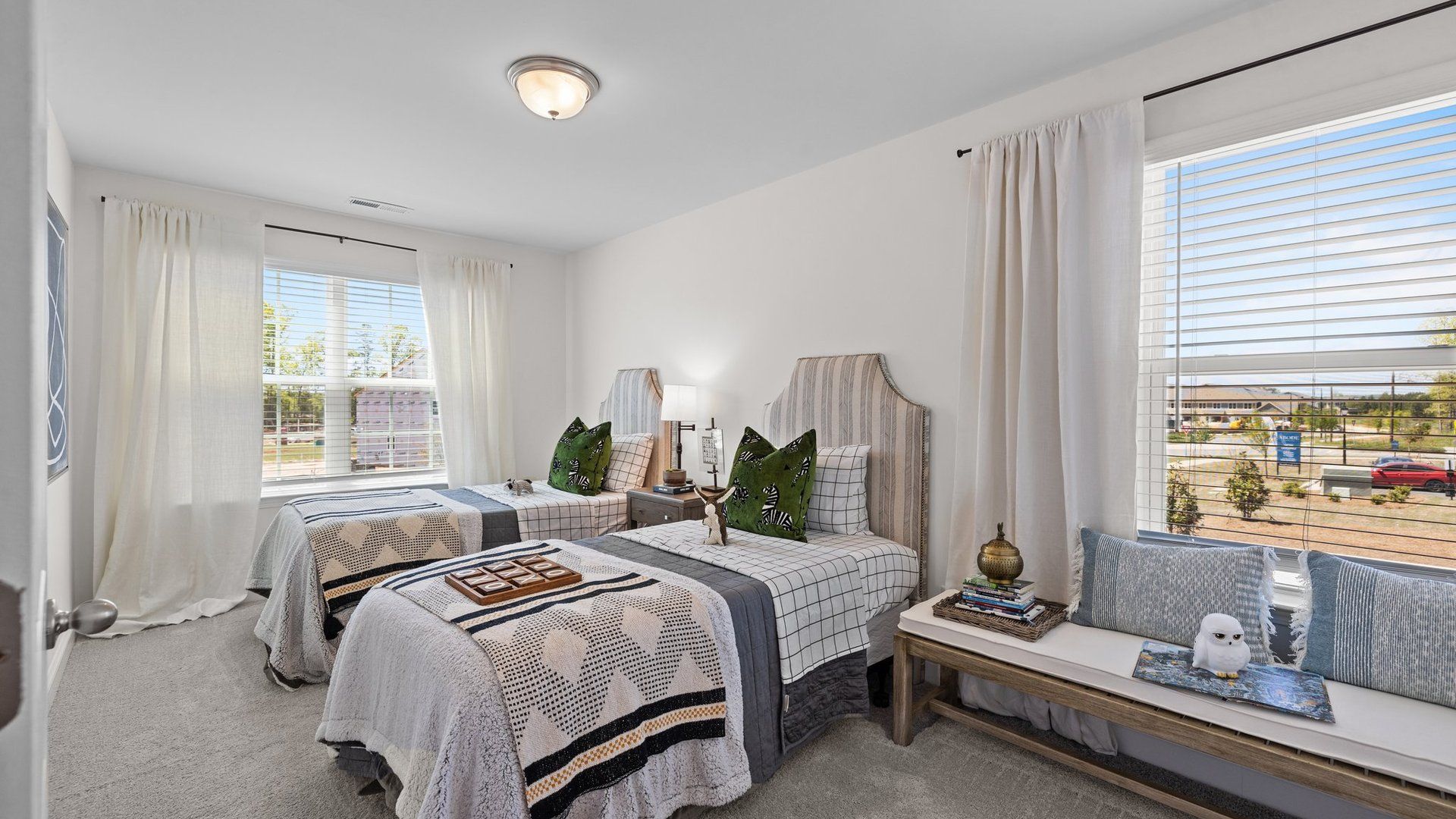 Spacious corner bedroom with large windows and elevated ceiling in the Rochester Design by DRB Homes Charlotte, NC
