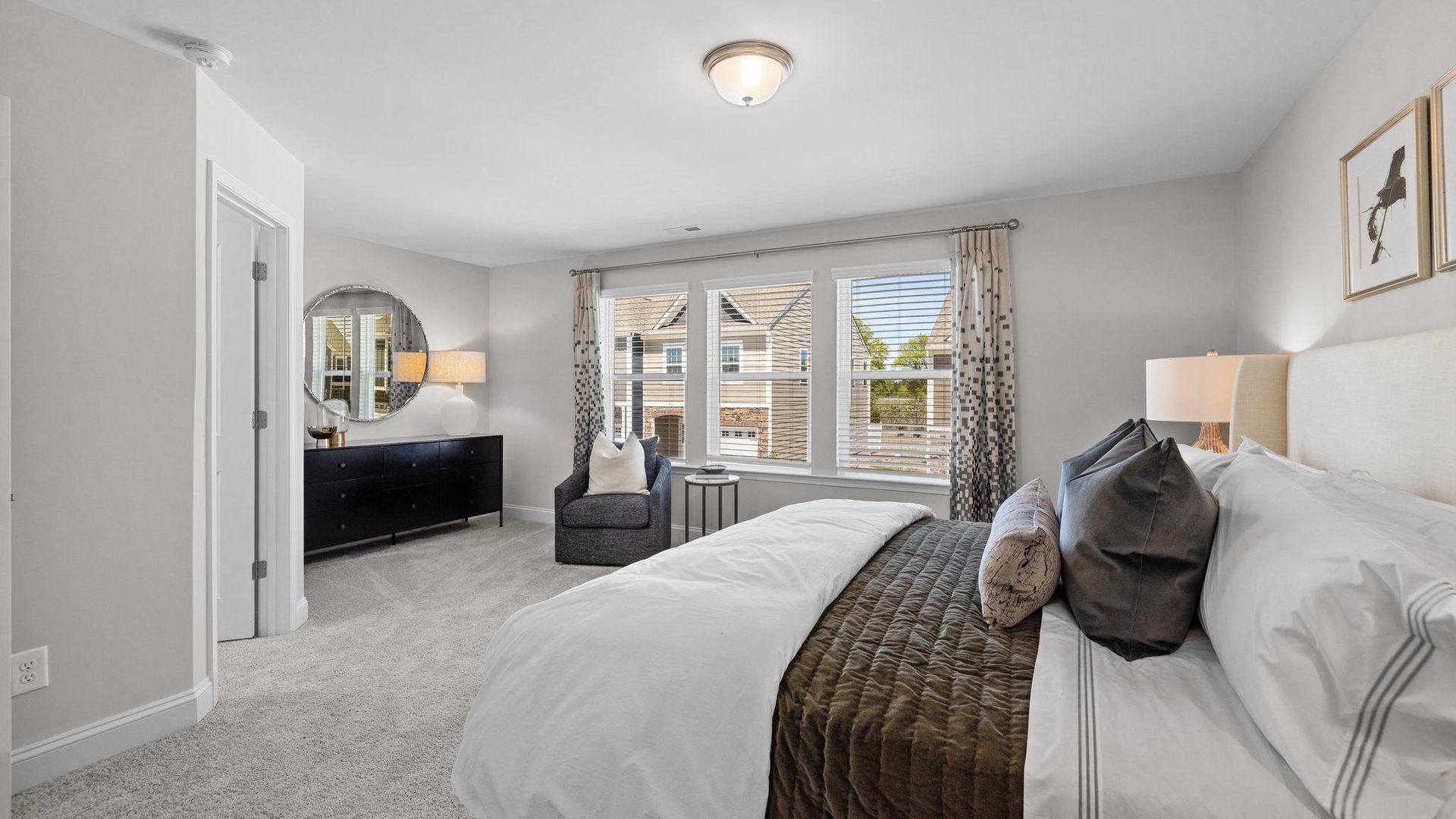 Primary bedroom with extra space, seating area, and large walk-in closet in the Rochester Design by DRB Homes Charlotte, NC