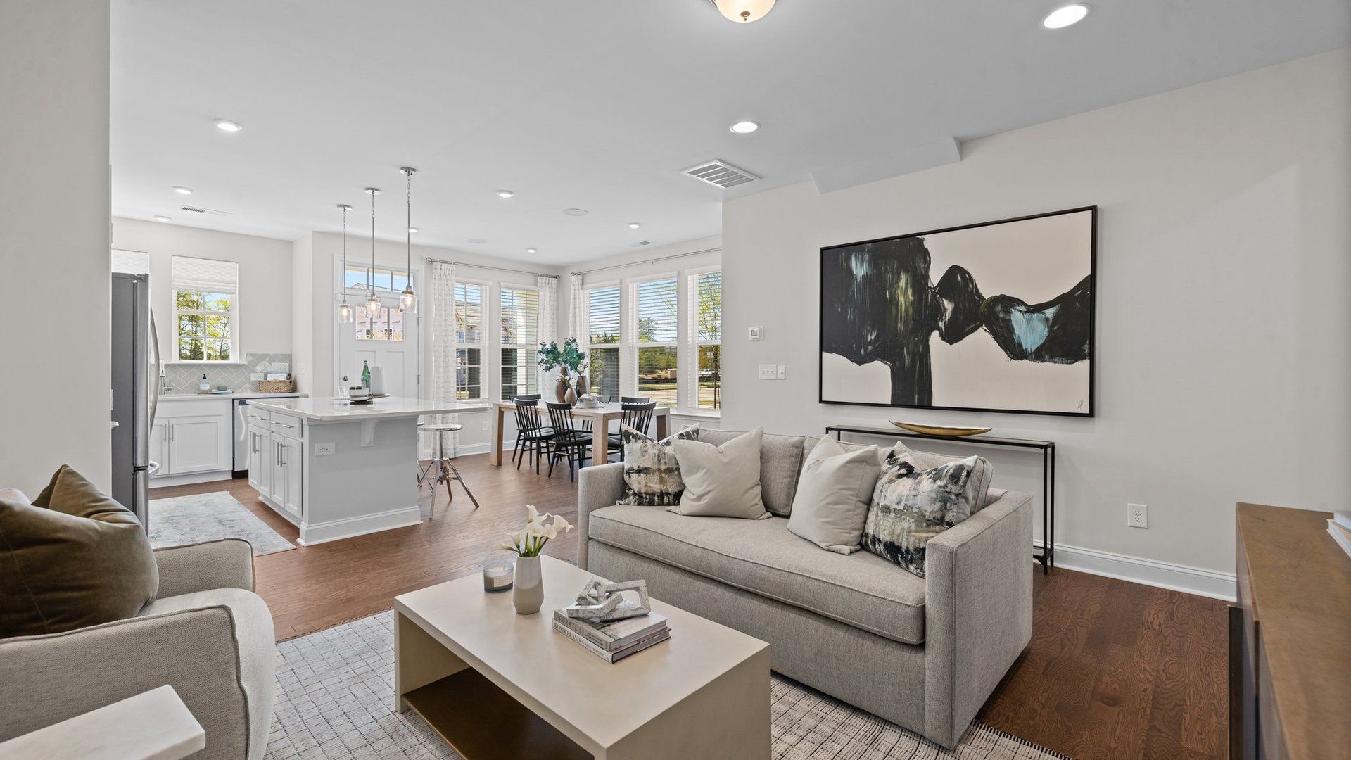 The Rochester bright and open floor concept family room, kitchen, dining, and large windows. DRB Homes. Charlotte, NC.