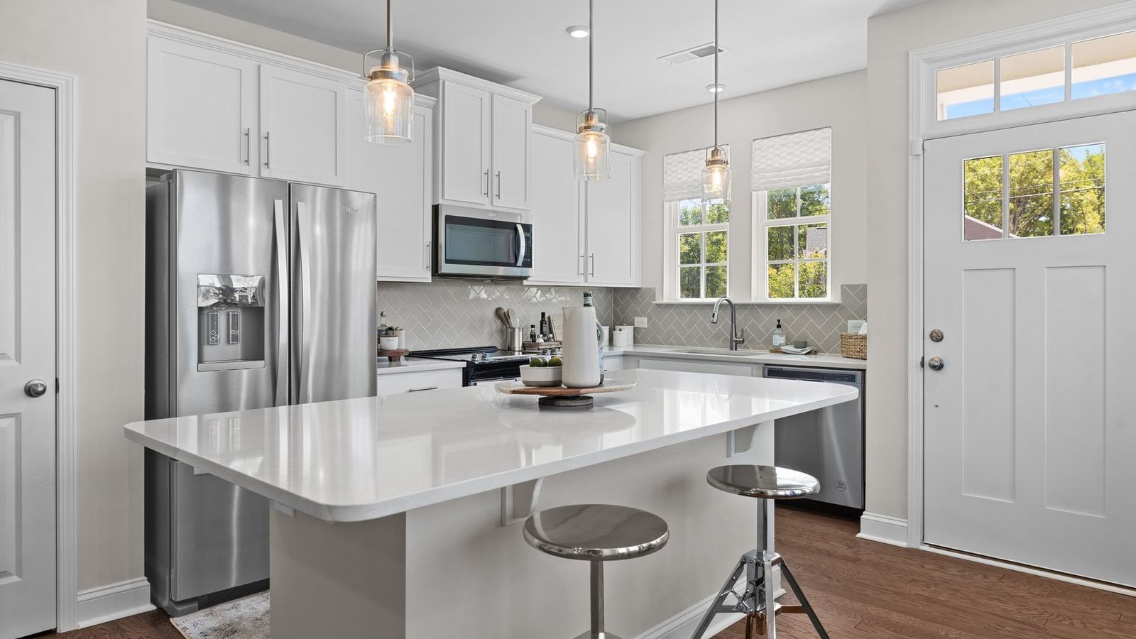 Rochester kitchen features cascading cabinets, large island, & premium finishes. Greenway Overlook. DRB Homes. Charlotte, NC