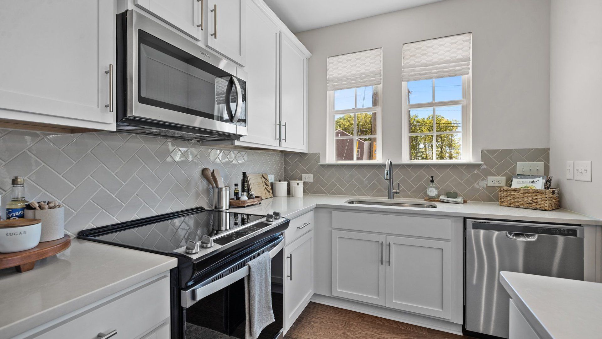 The Rochester kitchen with large single-basin sink, stainless steel range, microwave, & dishwasher. DRB Homes. Charlotte, NC.
