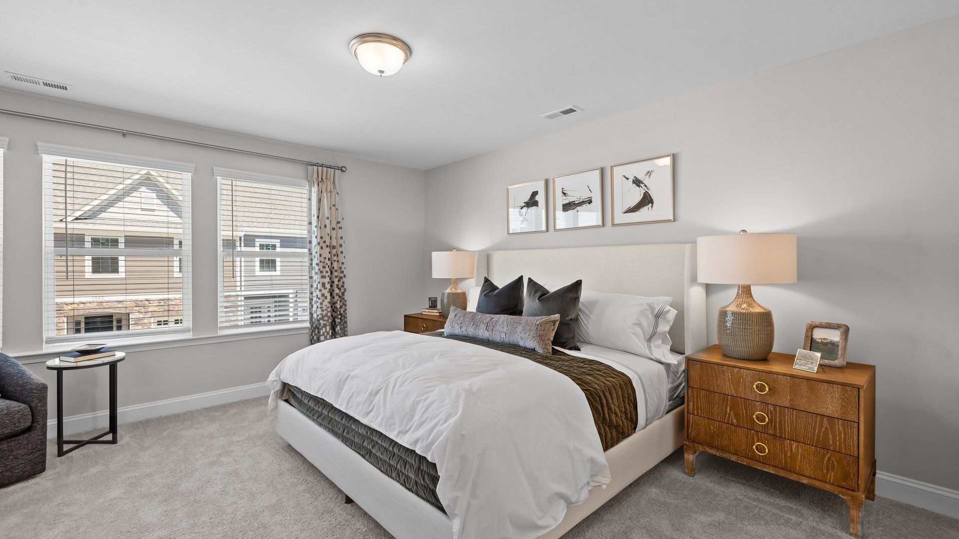 Rochester bright primary bedroom with large windows, plush carpeting, and premium finishes. DRB Homes. Charlotte, NC