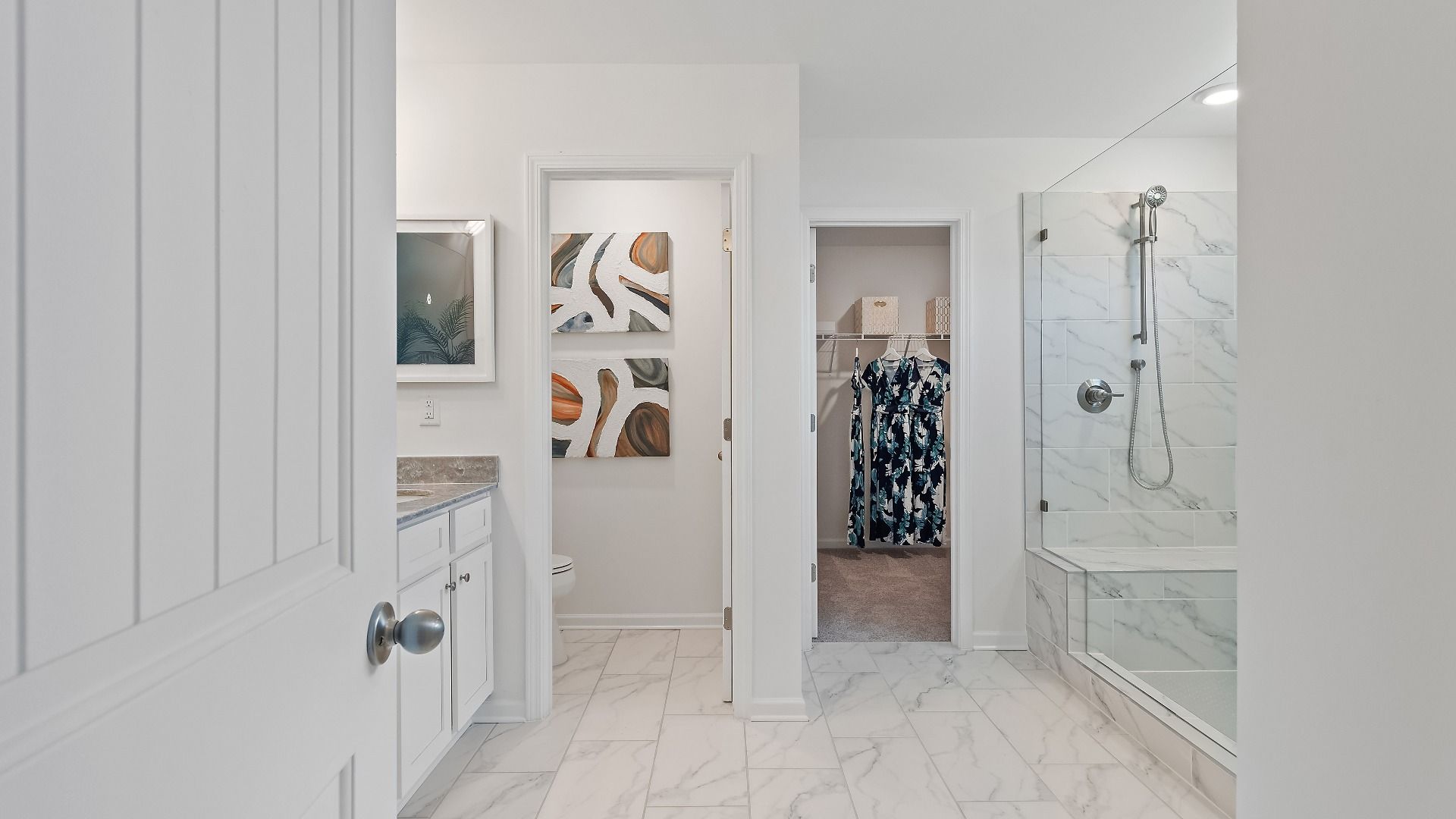 Luxury Wagener primary bath with tile flooring, tiled walk-in shower, and modern finishes at Burchwood in Stockbridge, GA.