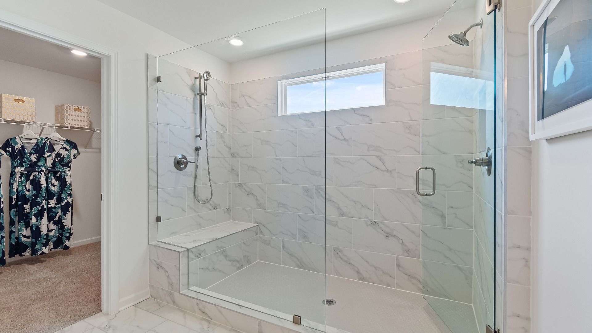 Primary bath with connected walk-in closet and generous tiled walk-in shower in the Wagener at Burchwood in Stockbridge, GA.