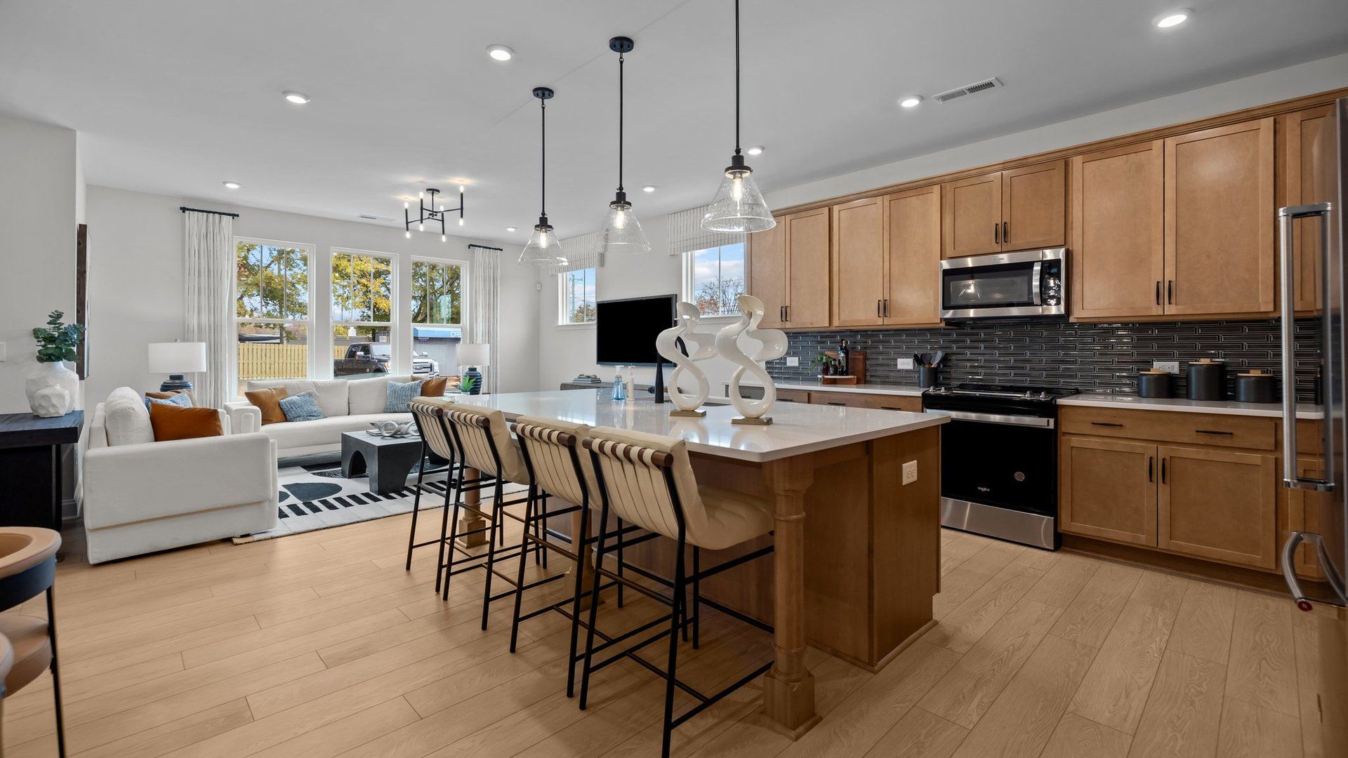 Kitchen with large island, premium lighting, and stylish cabinetry. New townhome Adaline plan by DRB Homes Charlotte, NC